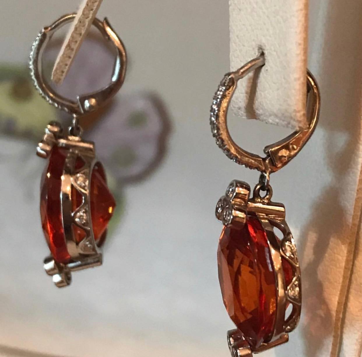 The unique Mandarine Garnet earrings in 18 K white Gold have a Diamond accent, French Backs and Side Detail
2 Oval Mandarin Garnets 23.81 CT's Total Weight
Diamonds approximately .50 CT's
Made in 18 K White Gold
one of a kind, made in NYC