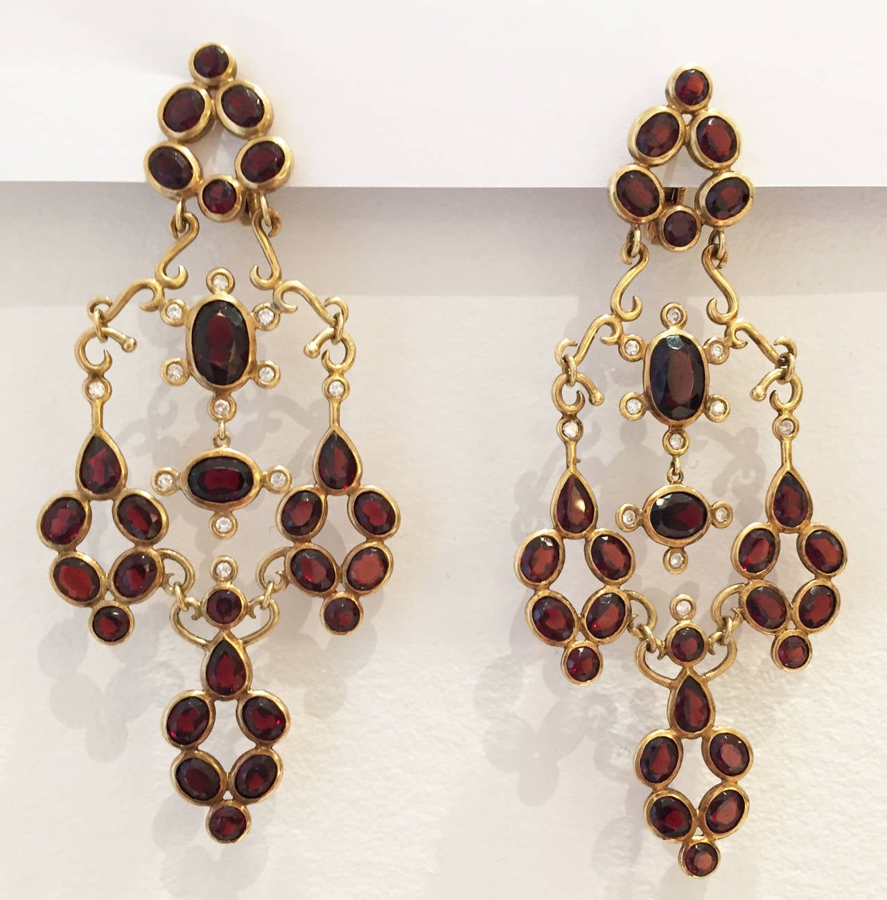 Pair of 18K gold, garnet and diamond chandelier earrings, ca. 1980s.  Signed H. Stern.