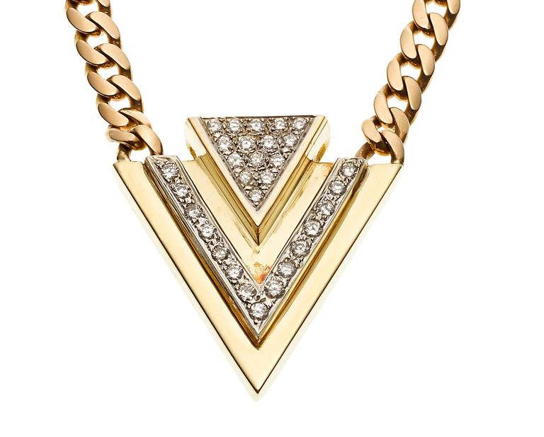 This geometric, 18K and diamond pendant hangs evenly from a substantial curb chain, approximately 18