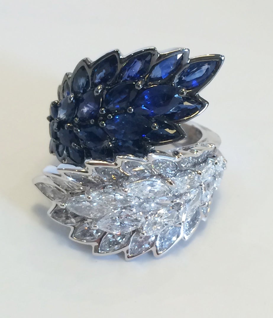 Layers of marquis-shaped sapphires and diamonds wrap around to create a stunning statement piece set in 18K white gold. Approximately 1