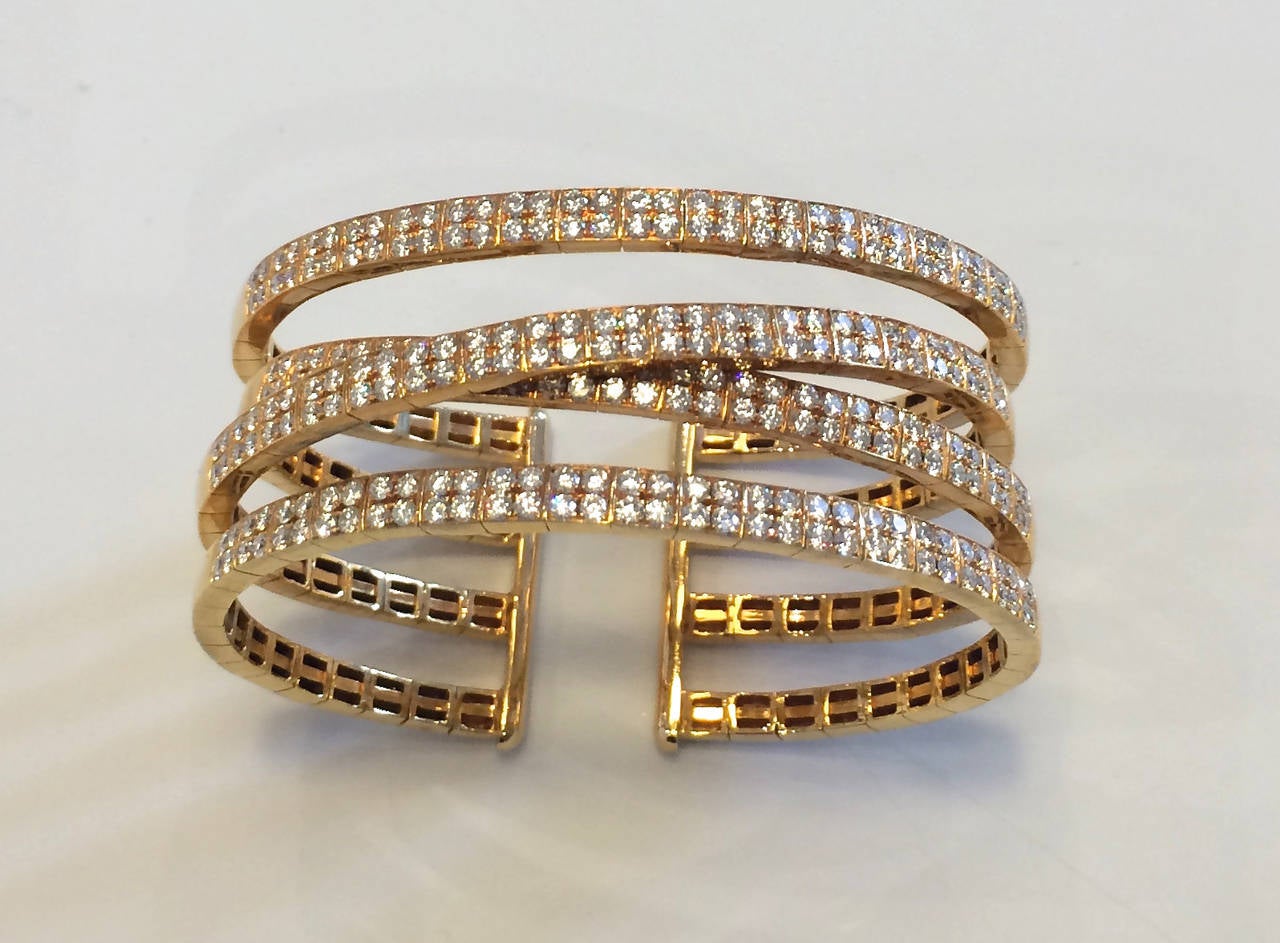 Four-band double row pavé diamond cuff bracelet set in 18K yellow gold. Size 6.5