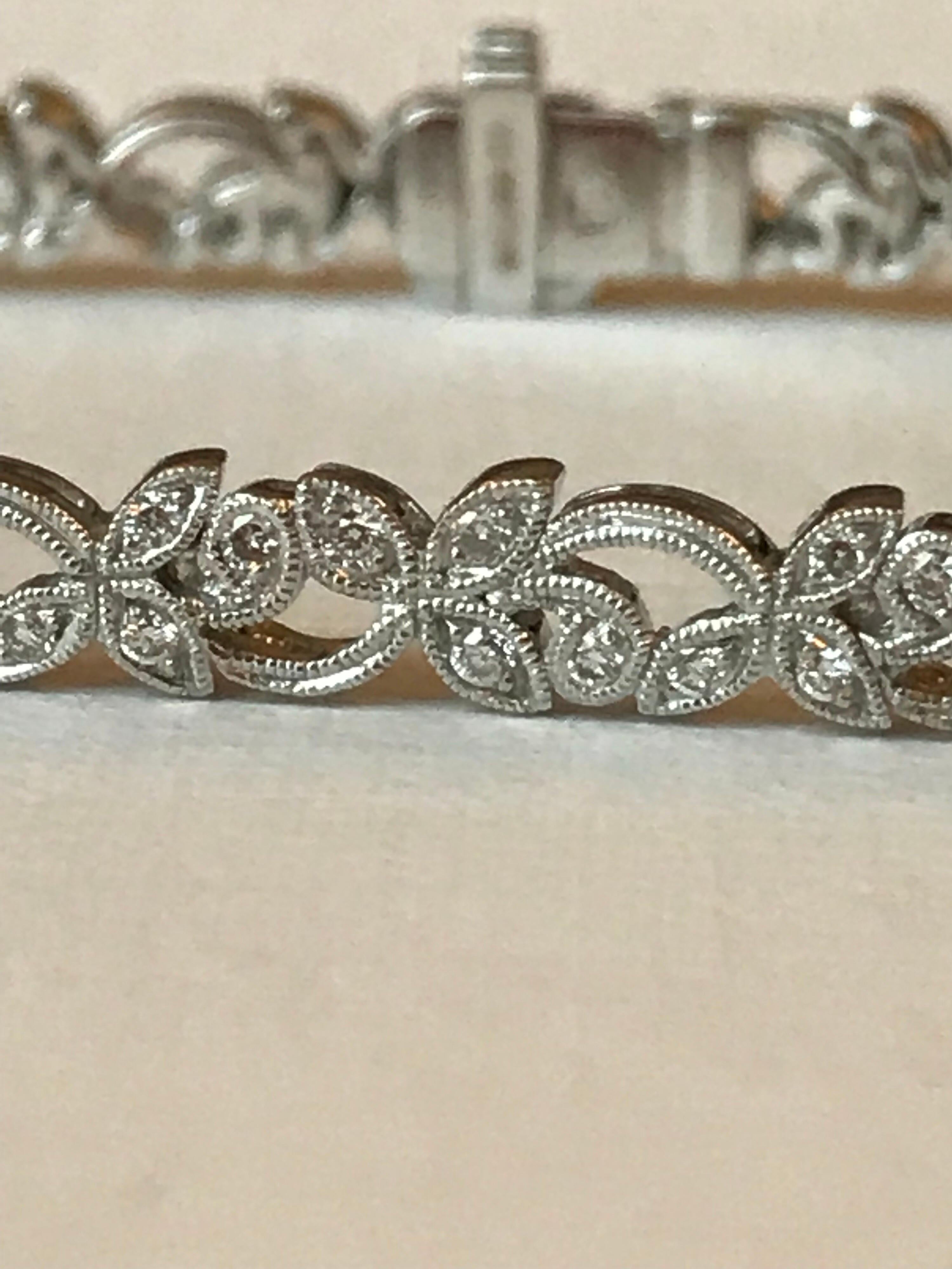 A diamond and 18k white gold milligrain bracelet with an intricate leaf pattern repeat.  At 18cms long, with a very good safety catch and is a wonderful bracelet which can be worn. The bracelet has an estimated diamond weight of 0.3cts.  It is very