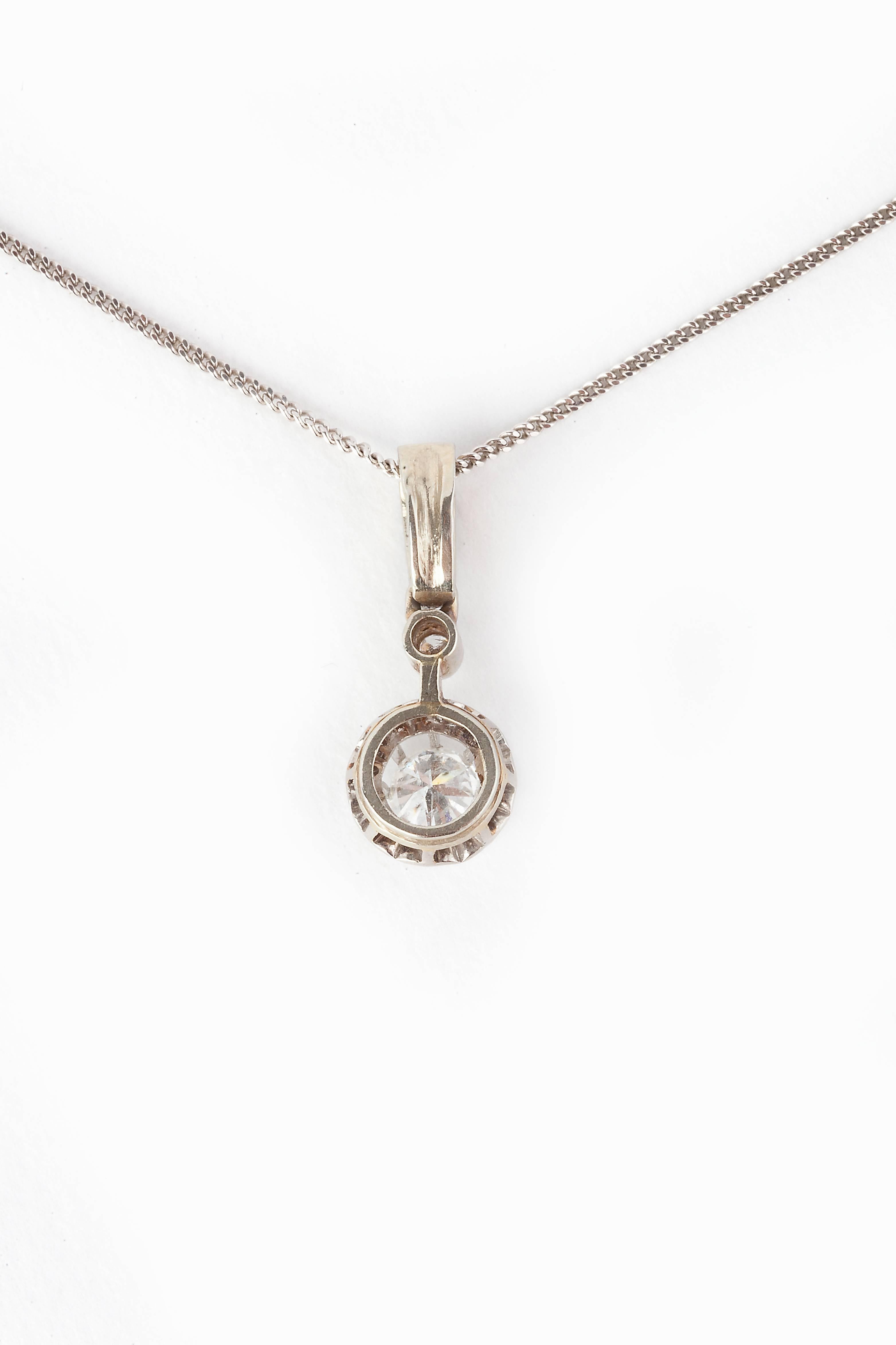 A diamond pendant, main stone 0.35cts, 0.5cts in total, VS1 colour E-F, set in platinum on an 18k gold chain, assay mark for France, Platinum on an 18k gold chain.