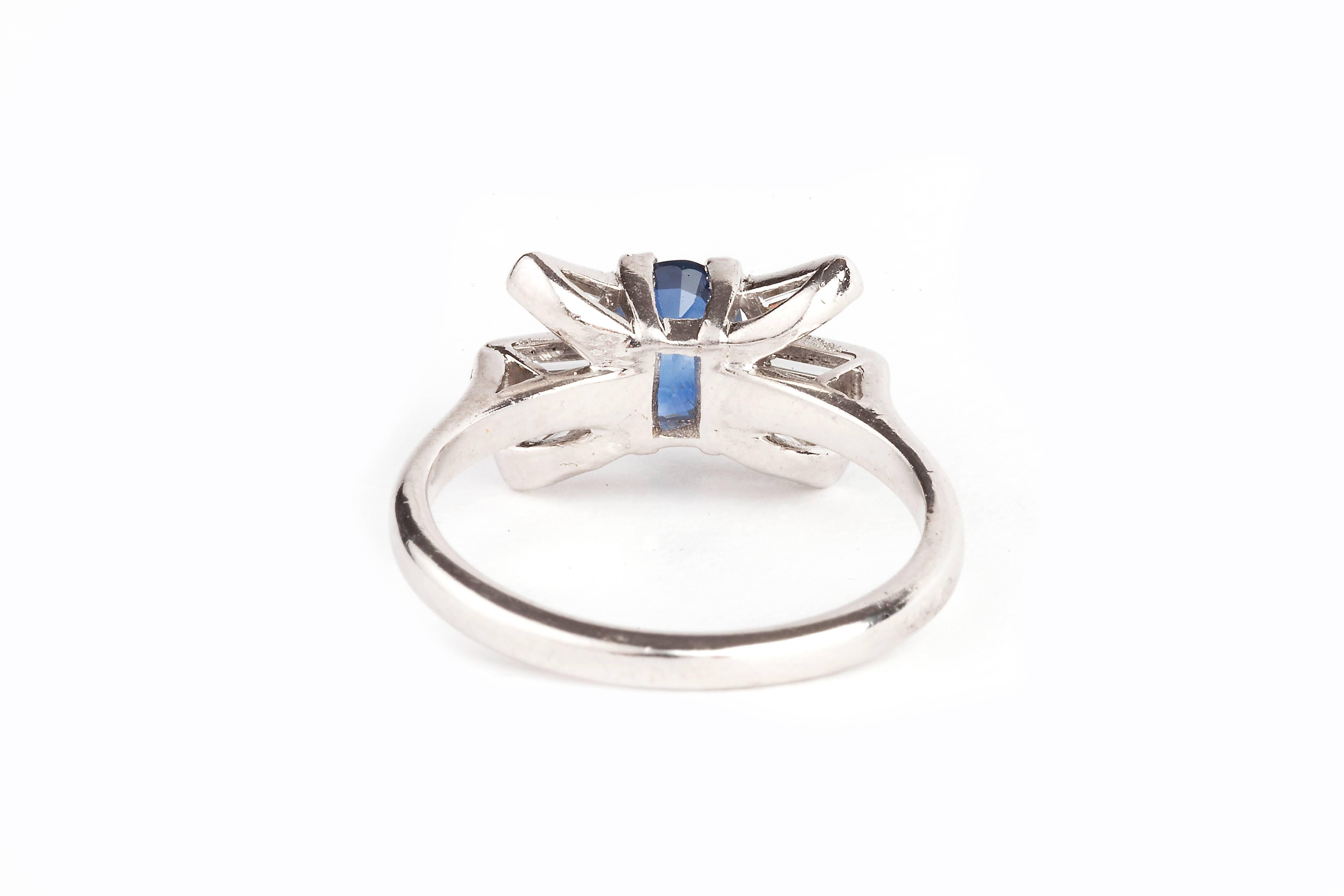 An art deco natural cornflower blue sapphire and diamond ring set in platinum.  The sapphire has a very good colour and is a natural sapphire, it is set with six baguette diamonds and hallmarked 'plat' inside the ring.  The ring dates from about