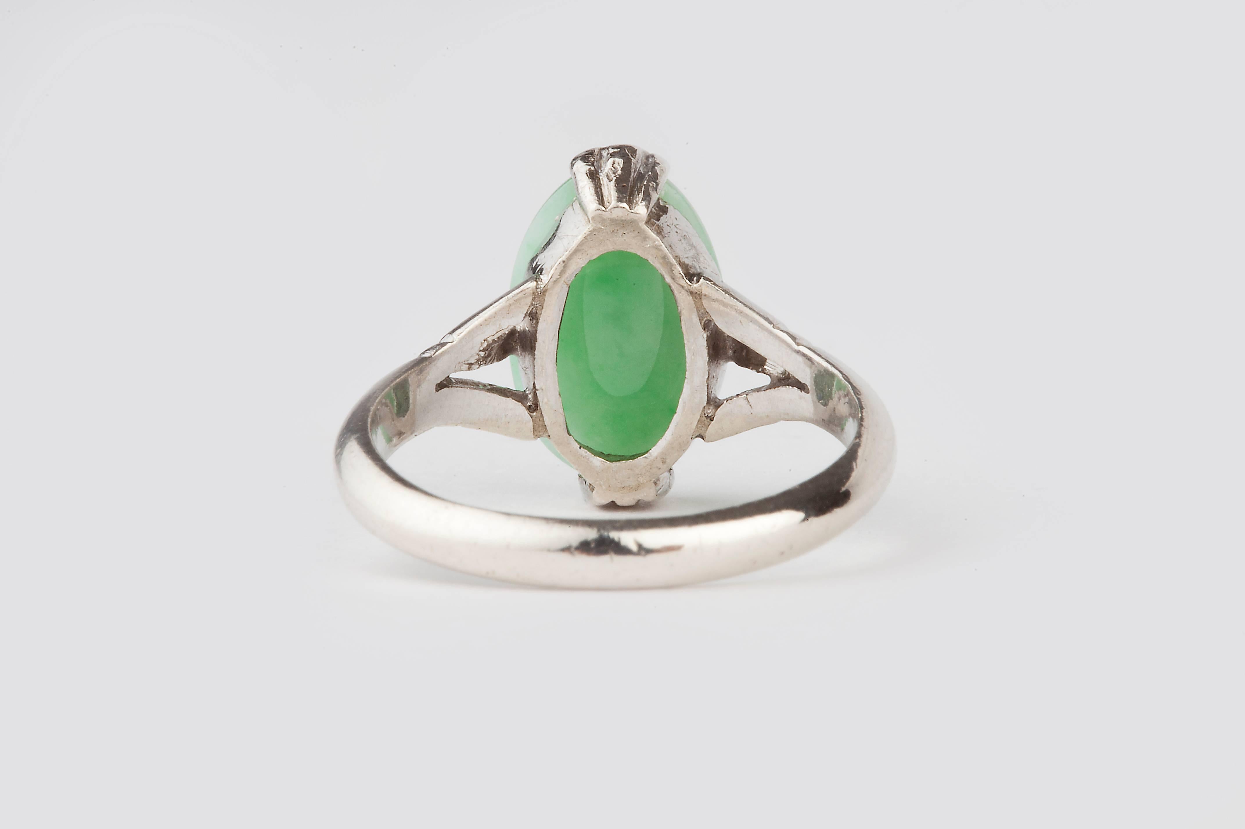 An Art Deco 18k white gold, natural apple green jade ring, the ring can be resized and posted out for the price listed, resizing usually will take one week.