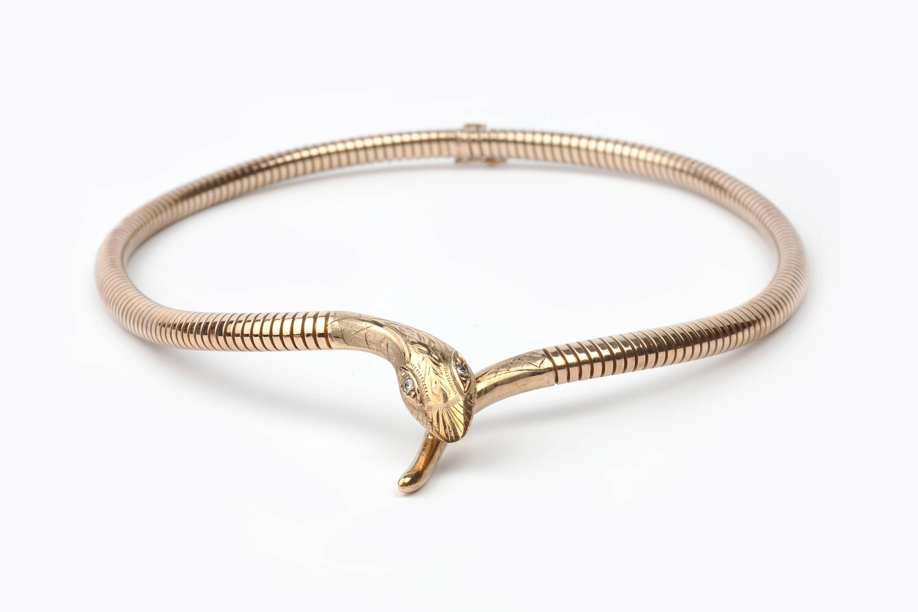 A Cropp and Farr 9K gold snake necklace from the 1980s, in beautiul condition, set with diamond eyes, about 0.10cts in total. The necklace sits well in the hollow of the neck.
