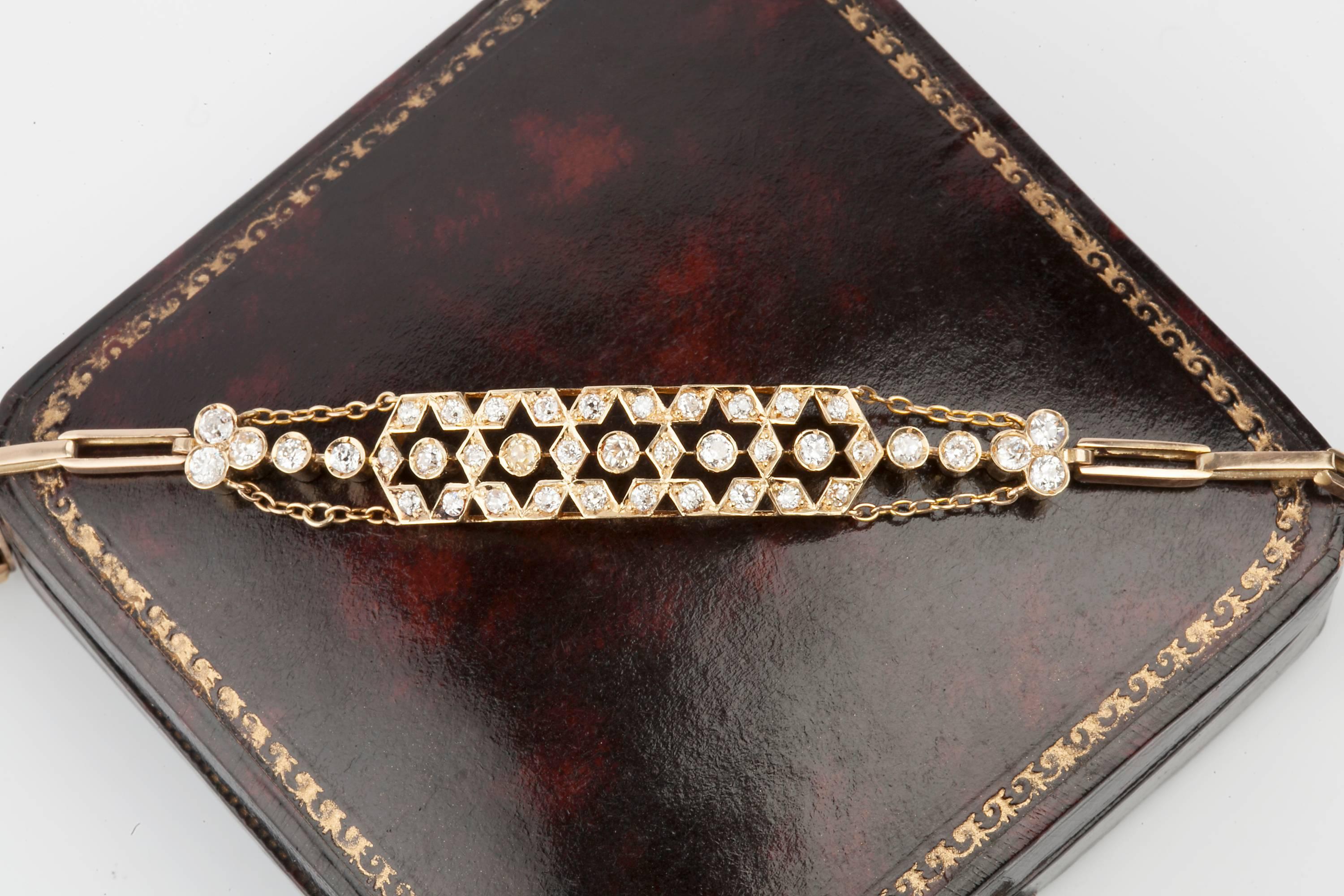 A diamond and gold Edwardian, old european cut, diamond bracelet set in high carat gold. 26 smaller diamonds and 15 larger diamonds are set in the bracelet to form a star pattern.  Diamond weight 1.5cts set with old brilliants. The diamonds are all