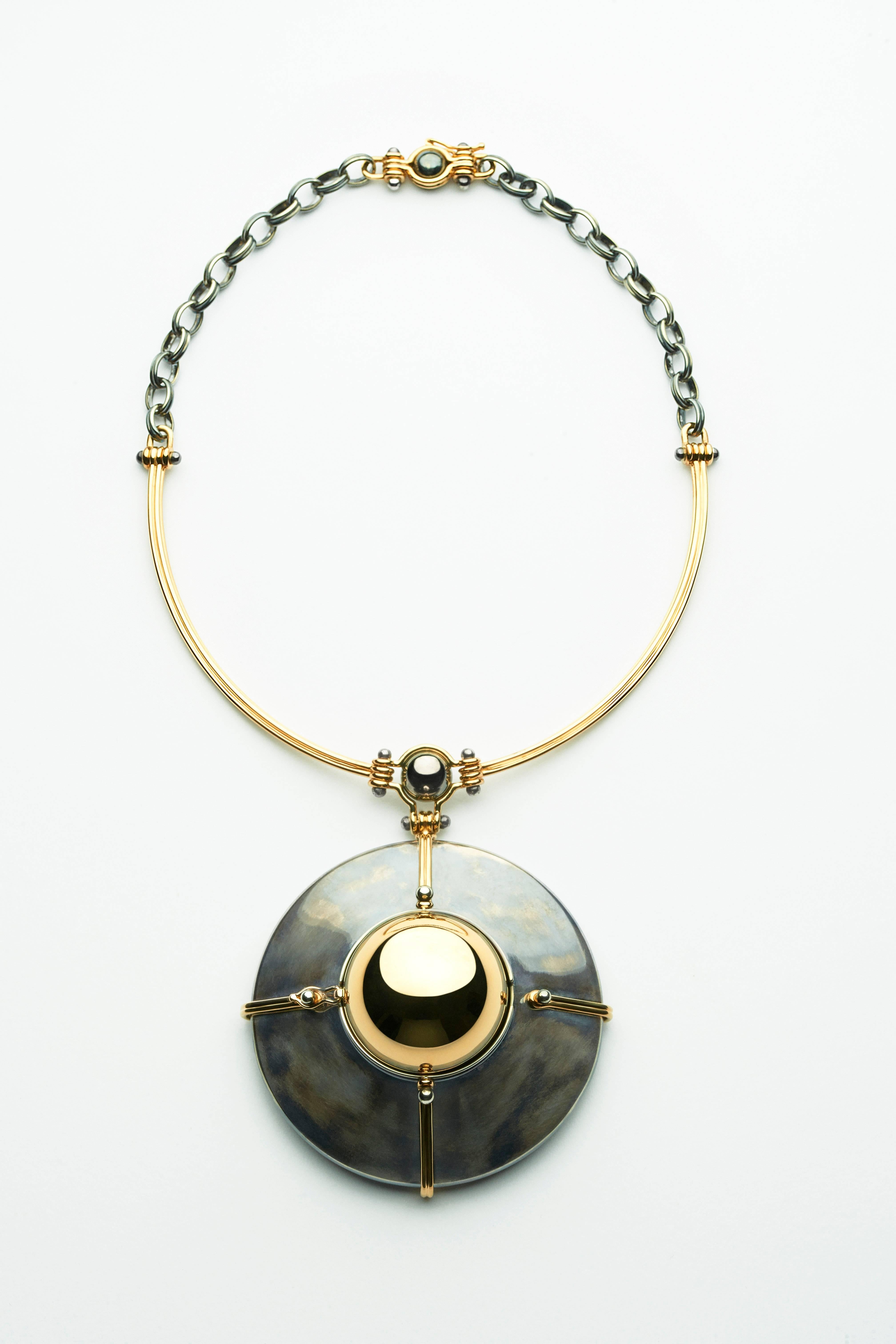 Scaphandre Pendant Yellow Gold Chrysocolle Diamond

Yellow Gold and Patinated silver choker pendant, made of an articulated yellow gold strand and a distressed silver chain. The Yellow gold sphere is rotating on a distressed silver structure bound