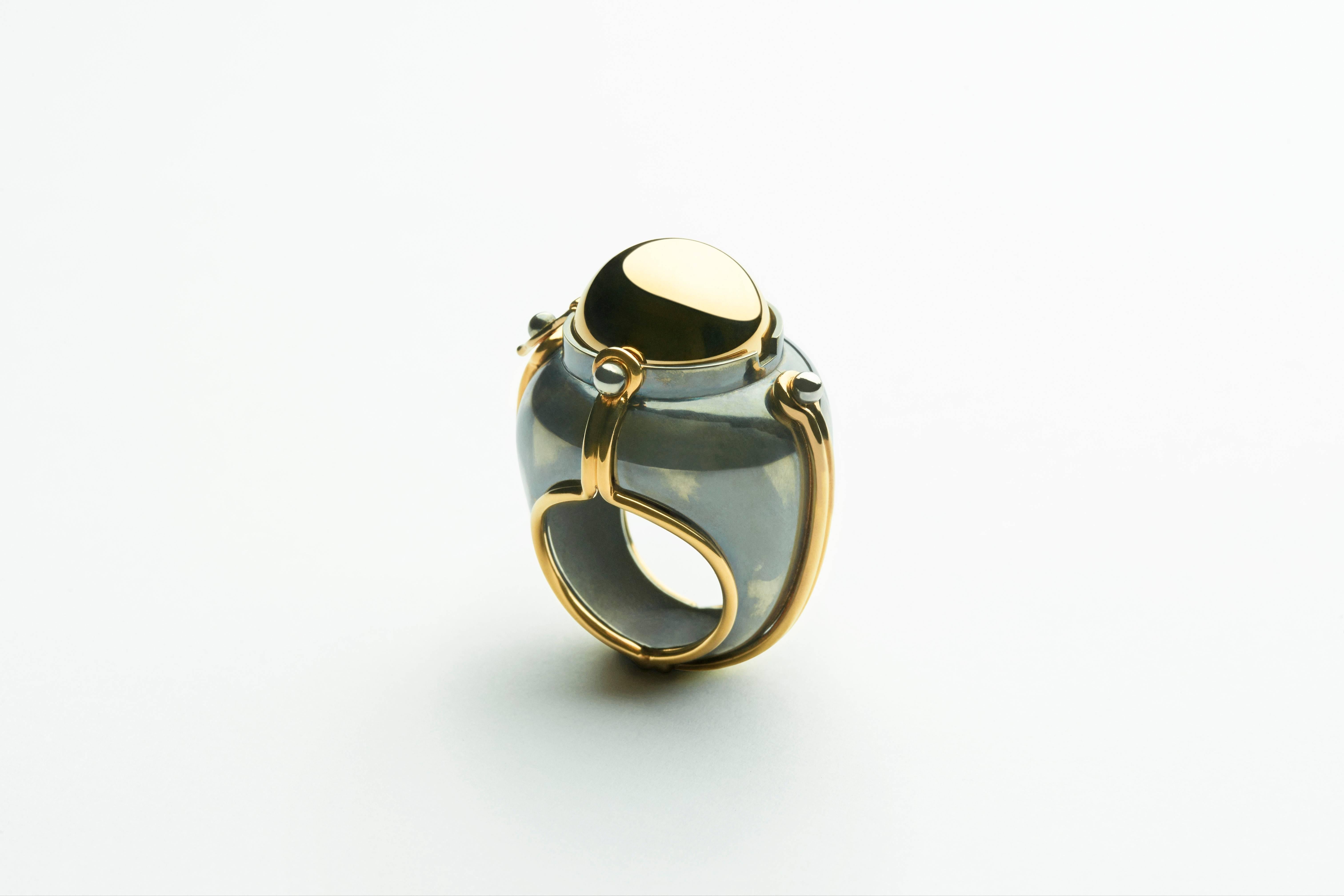 Ring Scaphandre Gold Silver Onyx Diamonds

Gold and Patinated silver ring.Yellow gold sphere rotating on a distressed silver structure bound by gold links and opening on a onyx globe itself surounded by a white gold satellite set with its