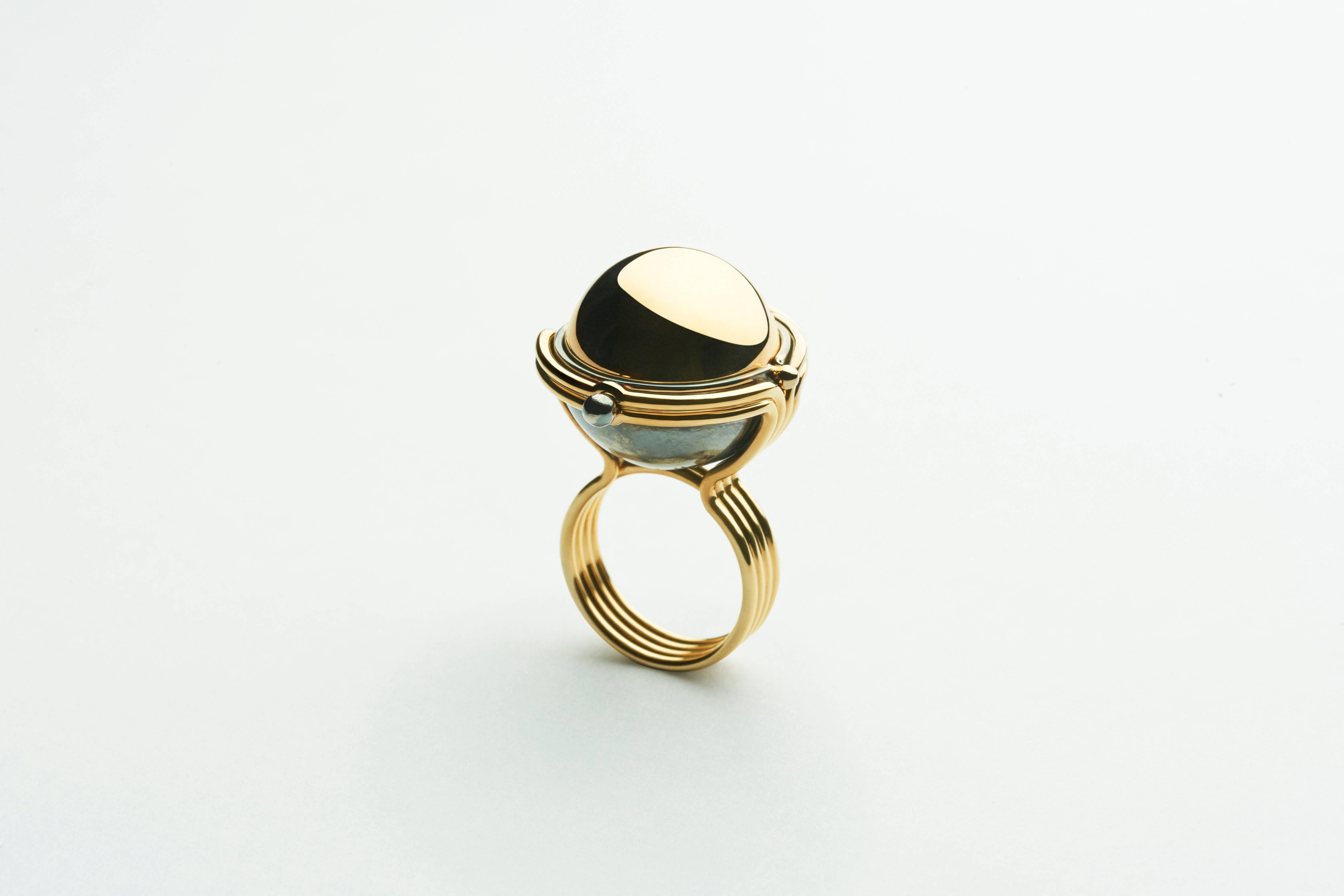 Ring Sphere Yellow Gold Diamonds

Gold ring made of 4 bands of gold. Yellow gold sphere rotating on a distressed silver structure and opening on a diamond studded globe itself surrounded by yellow and white gold satellites sporadically