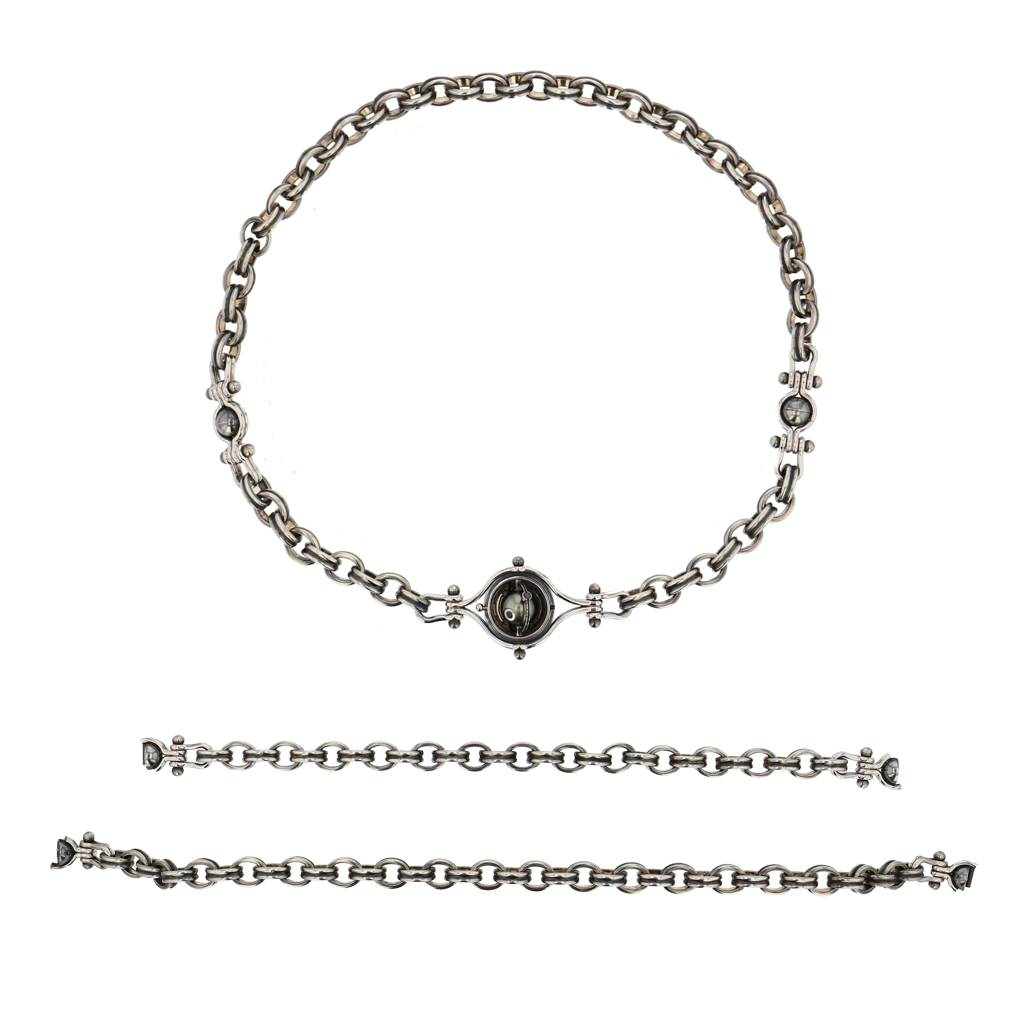 Necklace 3 Bracelets White Gold Silver Tahiti Pearl Diamonds

Necklace comprising a patinated silver chain, featuring two patinated silver mobile mechanisms supported by two white gold threads. Each of these bears a rotating white gold sphere which