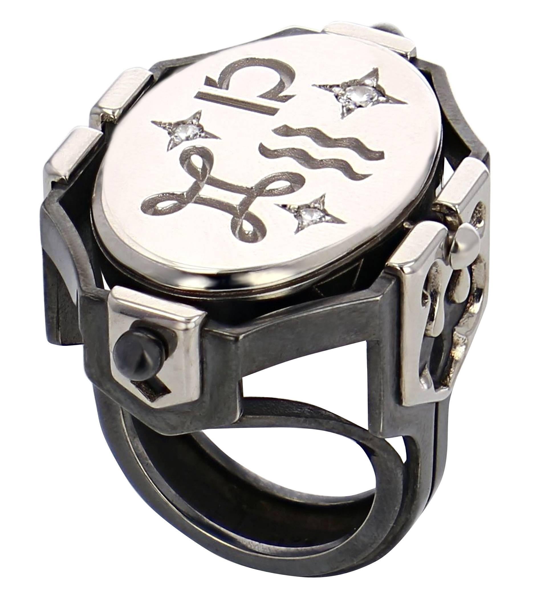 Seal Ring - AIR
Silver White Gold and Diamond large ring with rotating rock crystal center piece. 

Ring rail in patinated silver, adorned with gold coats of arms, pierced with motifs representing the seasons on the large ones and tarot colors on