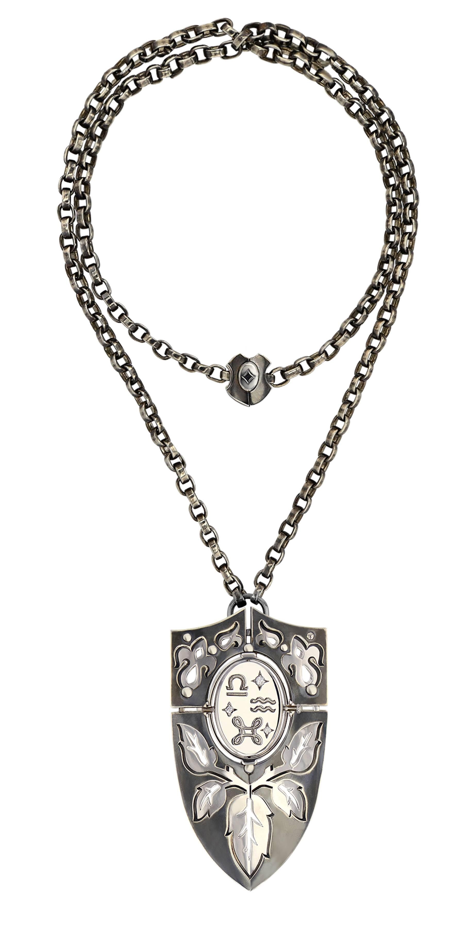 Shield Pendant AIR

Necklace of arms necklace mounted on a patinated silver chain, with a silver and yellow gold clasp engraved with tarot colors. The necklace is pierced, revealing plates with embossed motifs depicting the seasons. The pivoting