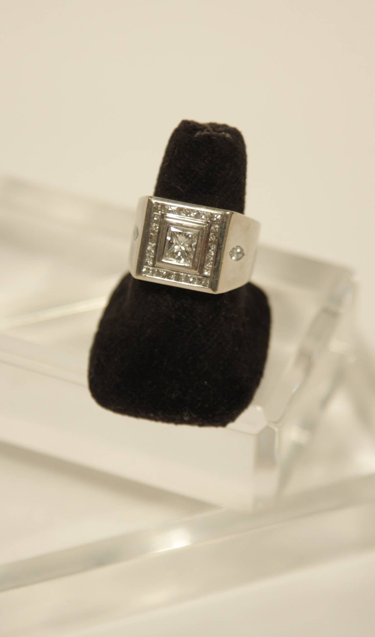 This wonderful Men's style ring is available by The Paper Bag Princess of Beverly Hills. The ring is 14K gold. The center stone is a  1.13 carat (approx.) square cut diamond, there are two side Marquise cut diamonds which weight (approximately)
