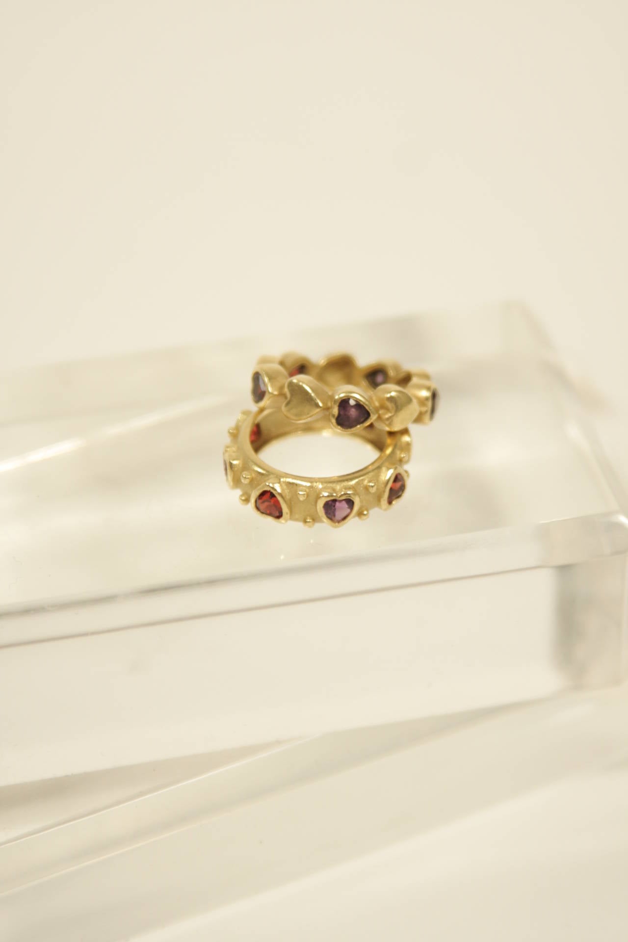18 kt Gold bands with Garnet and Amethyst heart setting