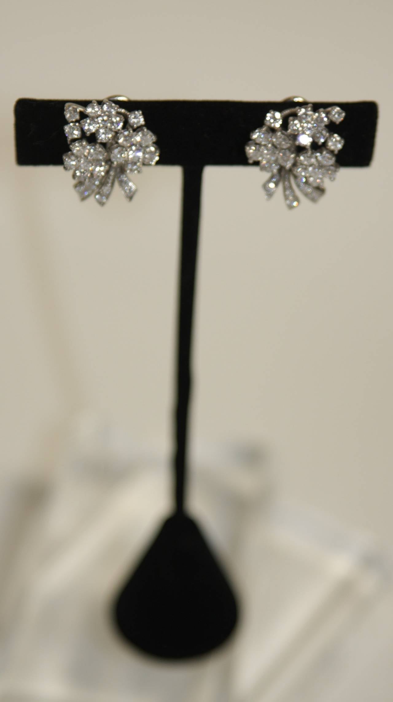 These are a pair of diamond and platinum floral motif earrings. They feature a clasp closure. They are a wonderful pair of earrings with amazing proportion.

Measures (Approximately)
Diamonds 3.60 carats
Length: 7/8