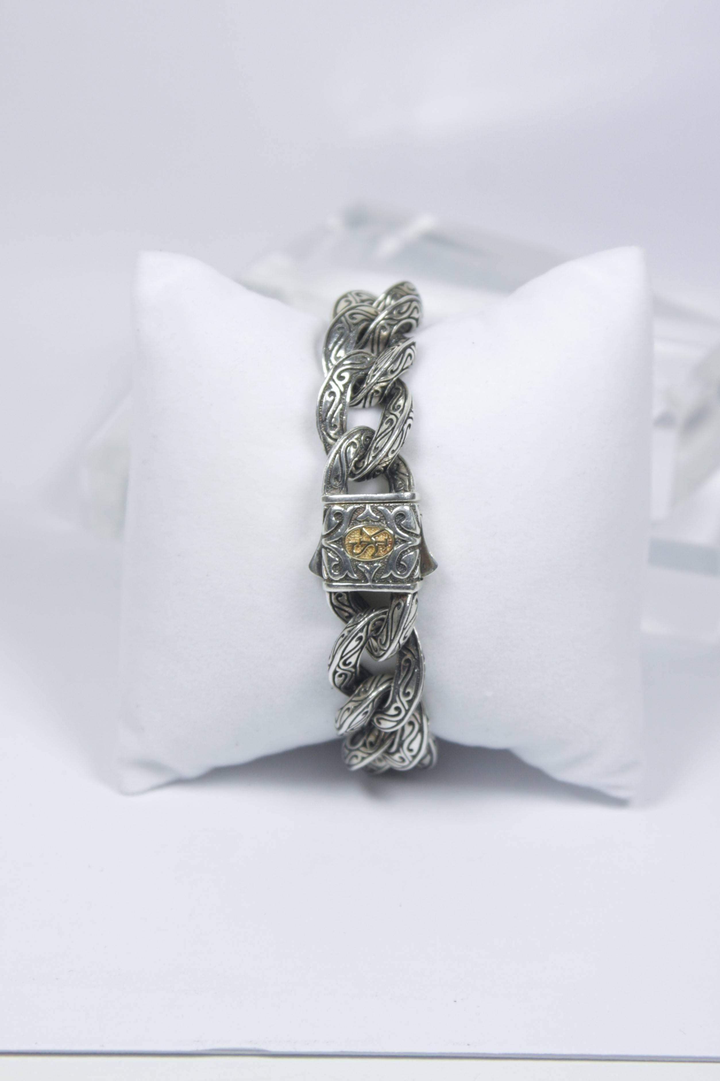 This Scott Kay men's bracelet is composed of a 18kt yellow gold and sterling silver. Features slide clasp closure with 