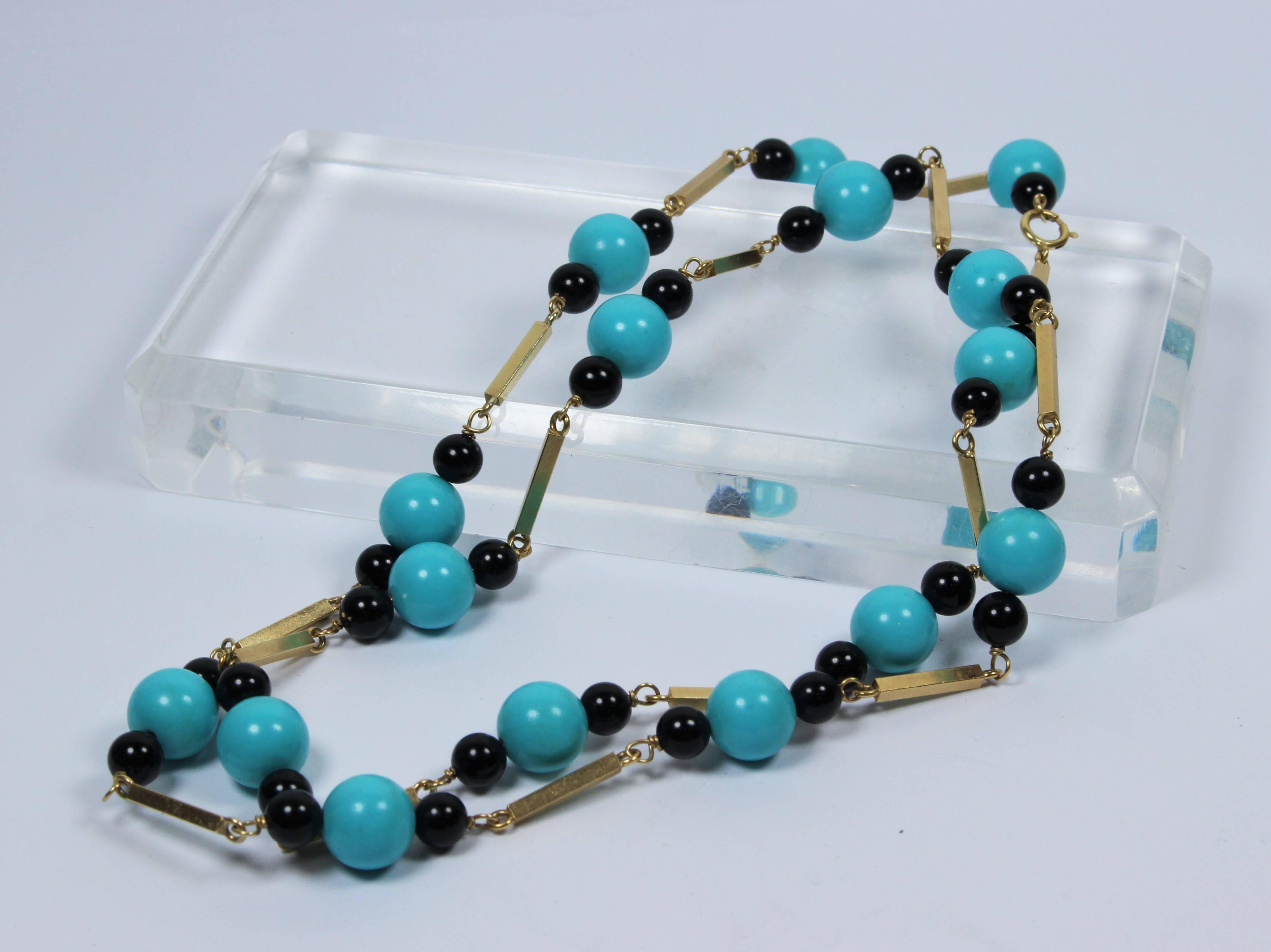 This vintage necklace is composed of 14KT yellow gold with onyx and turquoise. Can be worn doubled or single strand, features a clasp closure. In excellent vintage condition.

Specs: 
14KT Yellow Gold, Onyx, Turquoise  
Length: 27