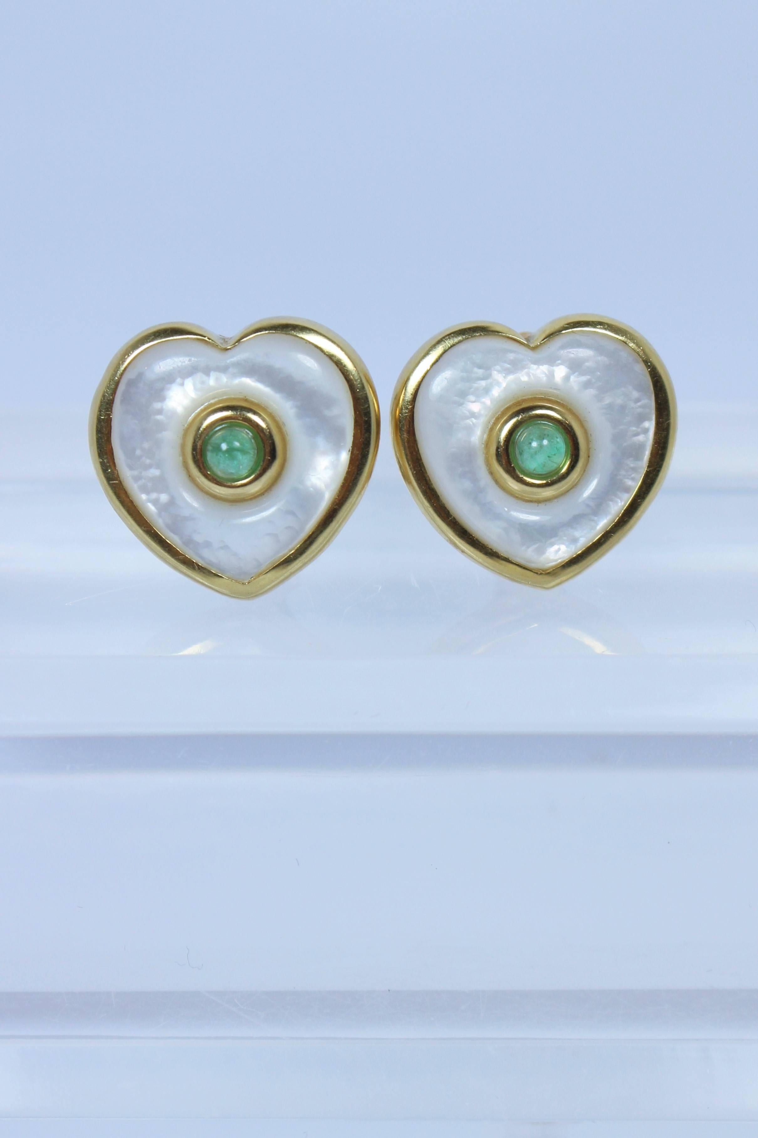 These earrings are composed of 18KT yellow gold with pearl and emerald center. There is a post and clasp back. In excellent vintage condition.

Specs: 
18KT Yellow Gold
Pearl 
Emerald 
  
Length: 3/4