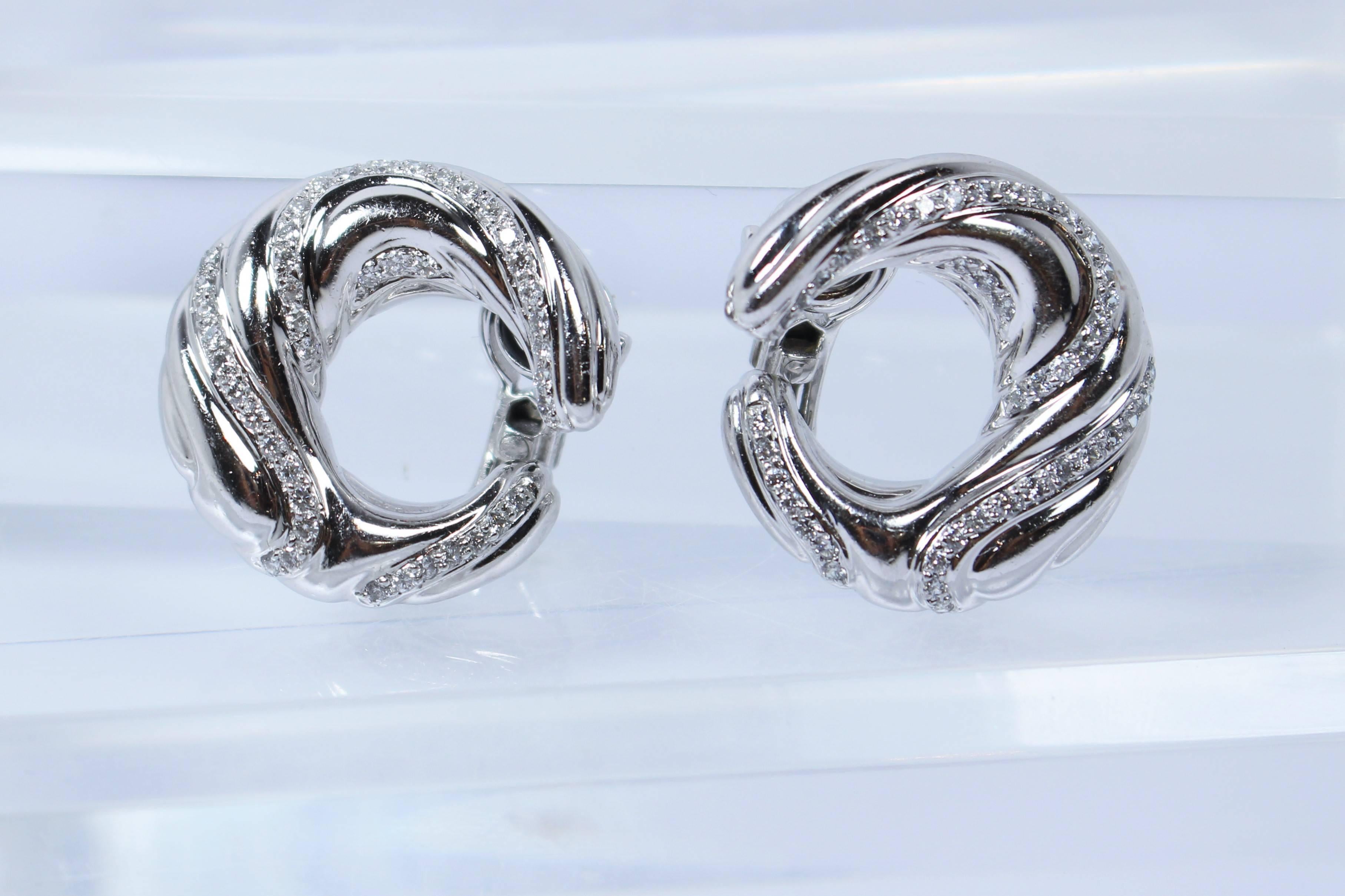 These earrings are composed of platinum and feature pave diamonds throughout the design. Features a tension clip backing/clasp. In excellent vintage condition.

Specs: 
Platinum 
86 Diamonds (Approximately 1.30 CTS Total Weight)

Length: 1