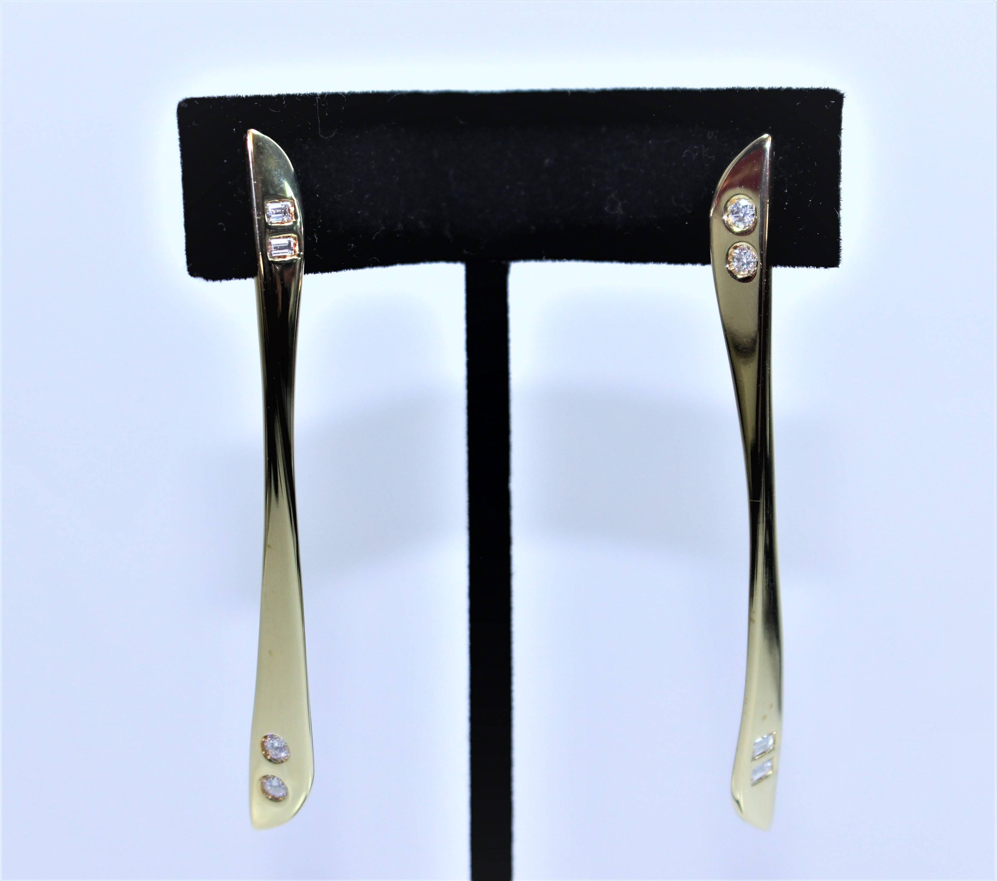 These earrings are composed of 18KT Gold and feature a sleek streamline design with inset diamonds. Made in Italy, circa 1960's. There is a post back.

Specs:
18 KT Yellow Gold
Diamonds: 
4- 0.10 Brilliant Cut Diamonds (Approximate carat