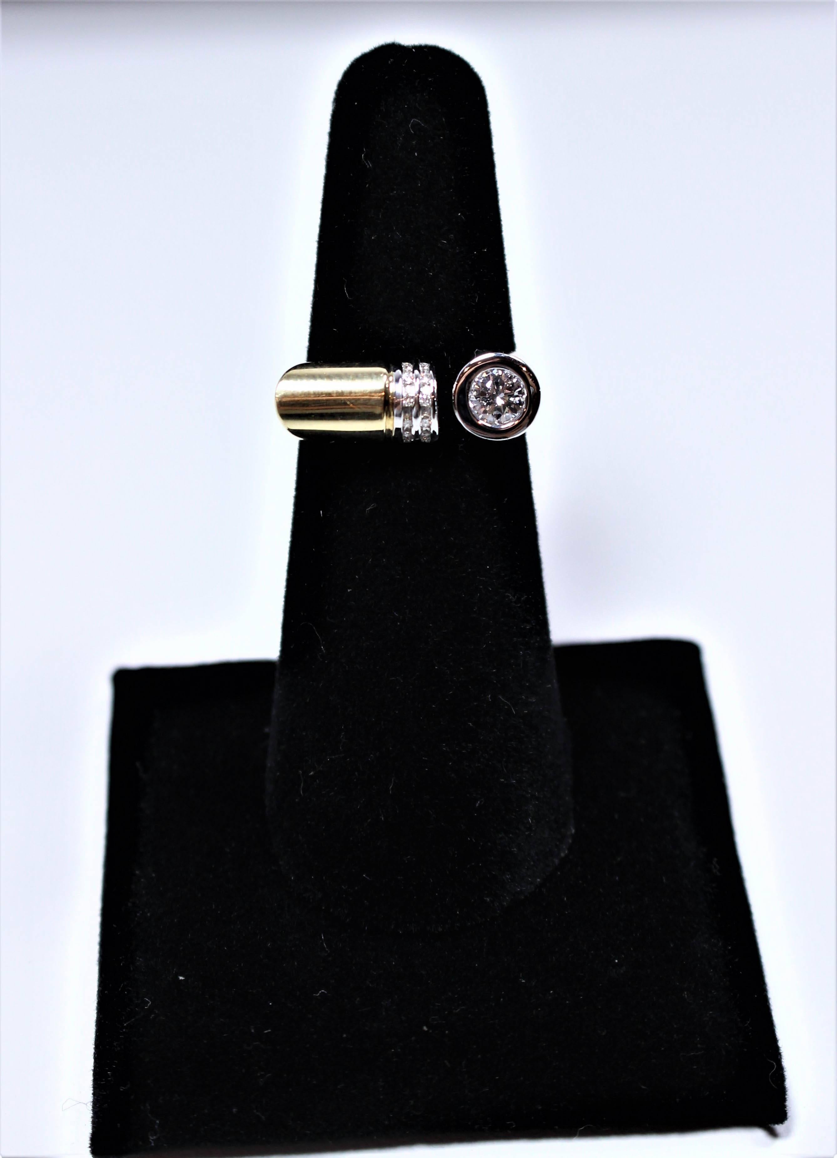 This ring is composed of a combination of 14kt white and yellow gold. Features an abstract style with pave and bezel set diamonds. This ring has a round cut bezel set stone with an approximate carat weight of 0.35 and 14 round cut pave set diamonds
