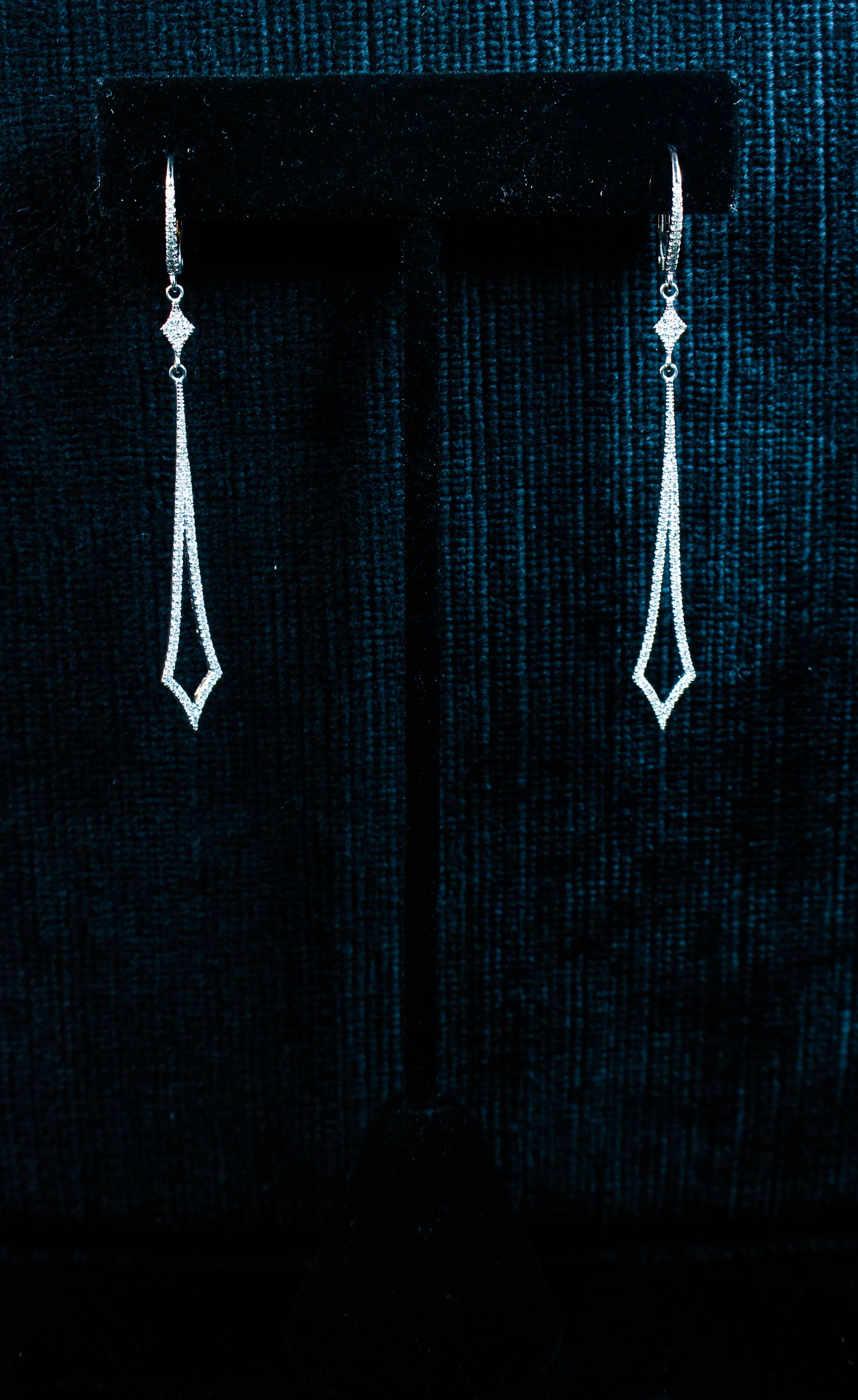 These stunning earrings feature a sharp streamline design with pave diamonds throughout. Specs below. In excellent condition.

Please feel free to ask any questions you may have, we are happy to assist. 

Specs:
14KT White Gold
Diamonds: 
Round Cut