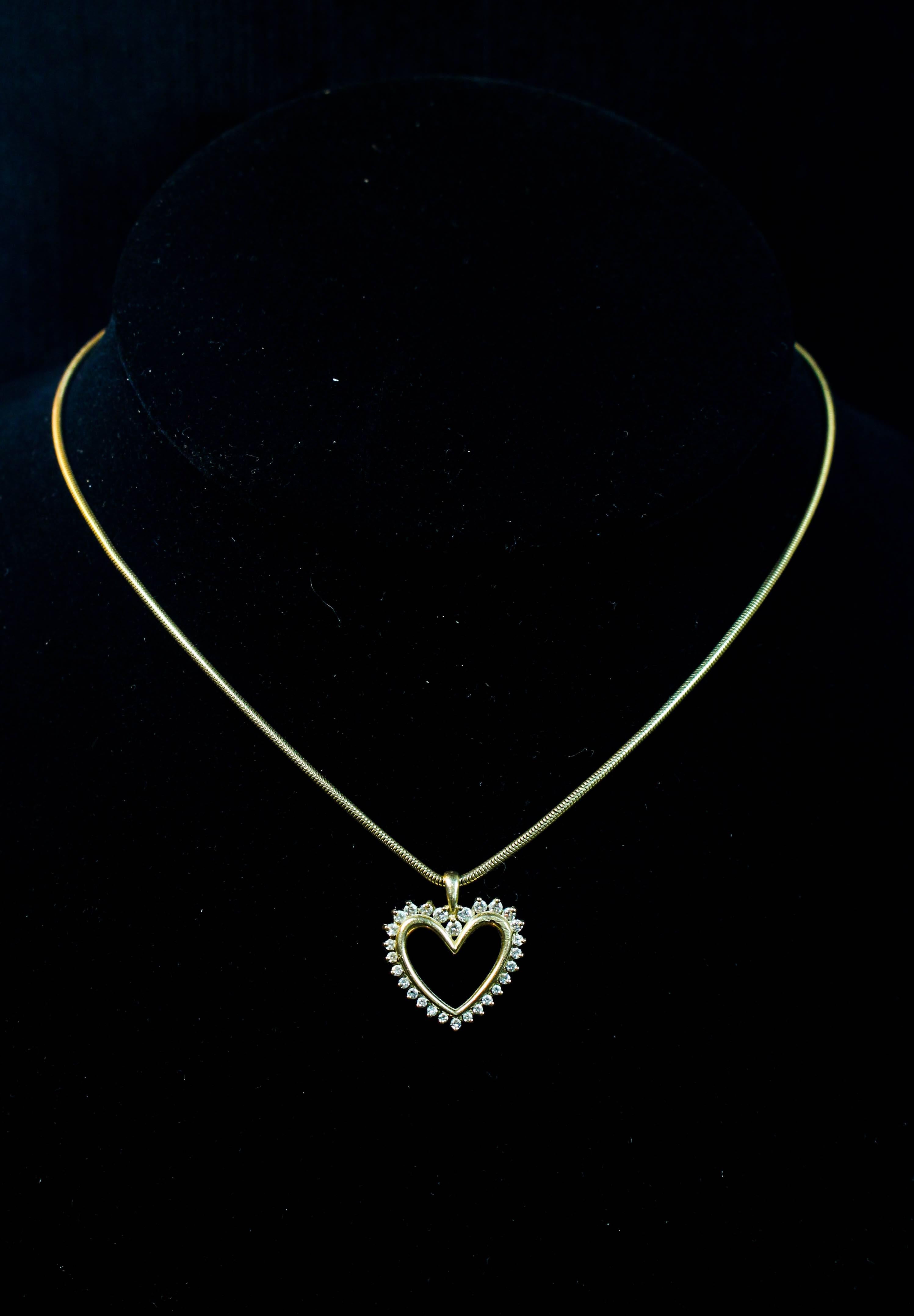 This necklace is composed of a 14KT yellow gold with a heart pendant accented with diamonds. Features a clasp closure. Specs below. In excellent condition.

Please feel free to ask any questions you may have, we are happy to assist. 

Specs:
14 KT