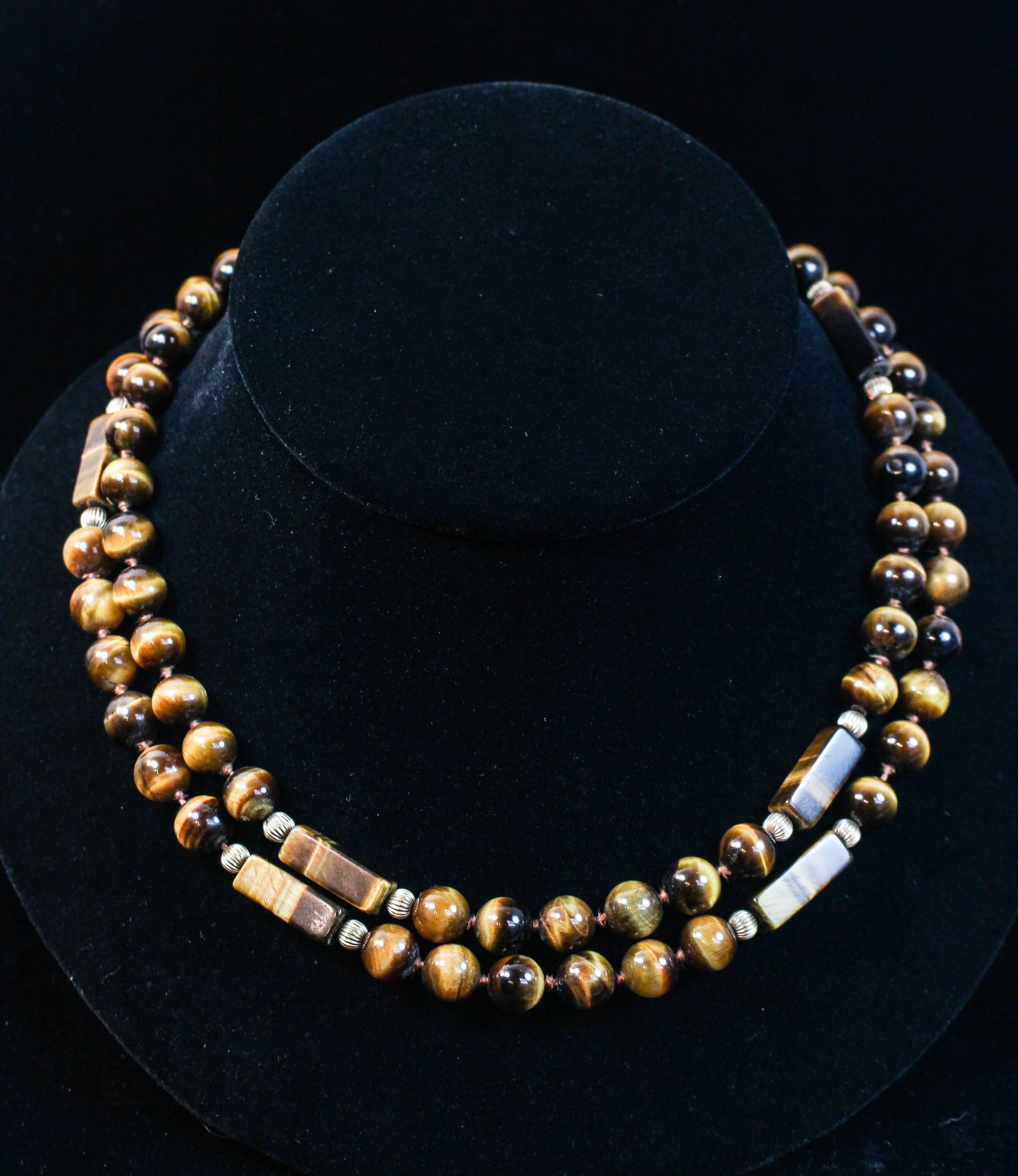 This necklace is composed of Tiger's eye round and rectangular beads, with 14KT gold beads an closure. Can be styled in a variety of fashions. In excellent condition.

Please feel free to ask any questions you may have, we are happy to assist.