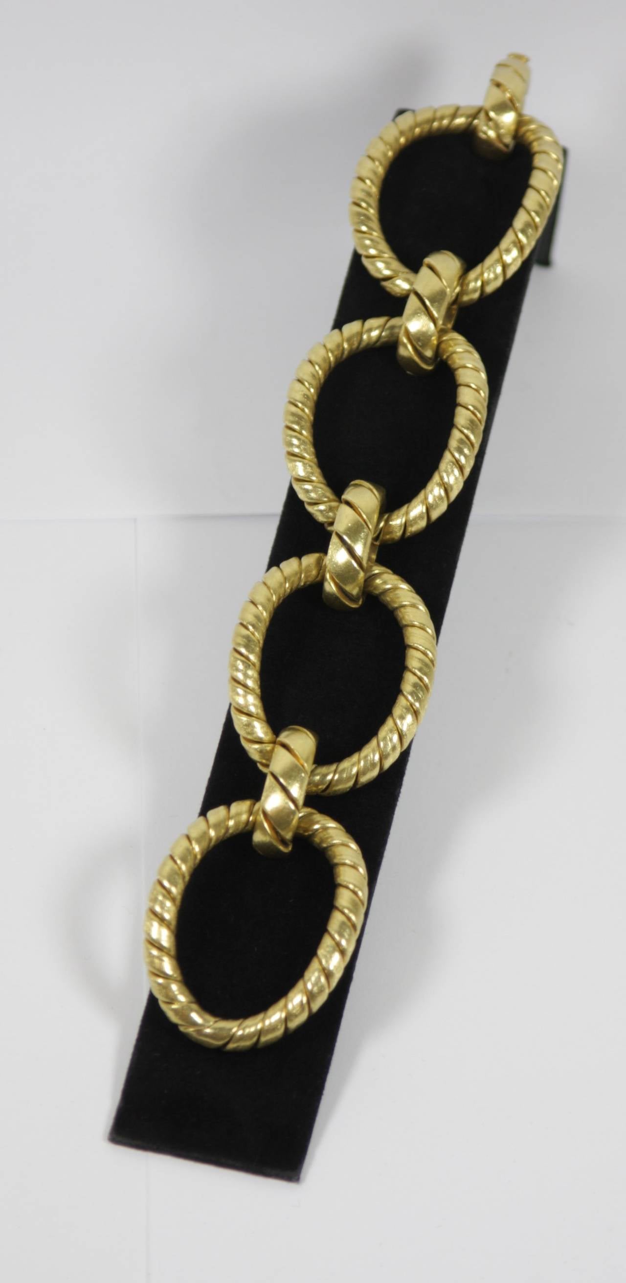 The bracelet is composed of a textured 18KT yellow gold. An absolutely stunning design. 

Specs:
18 KT Textured Yellow Gold
Gold: 89.3 Grams
Length 8 inches
Link Height 1.5 inches