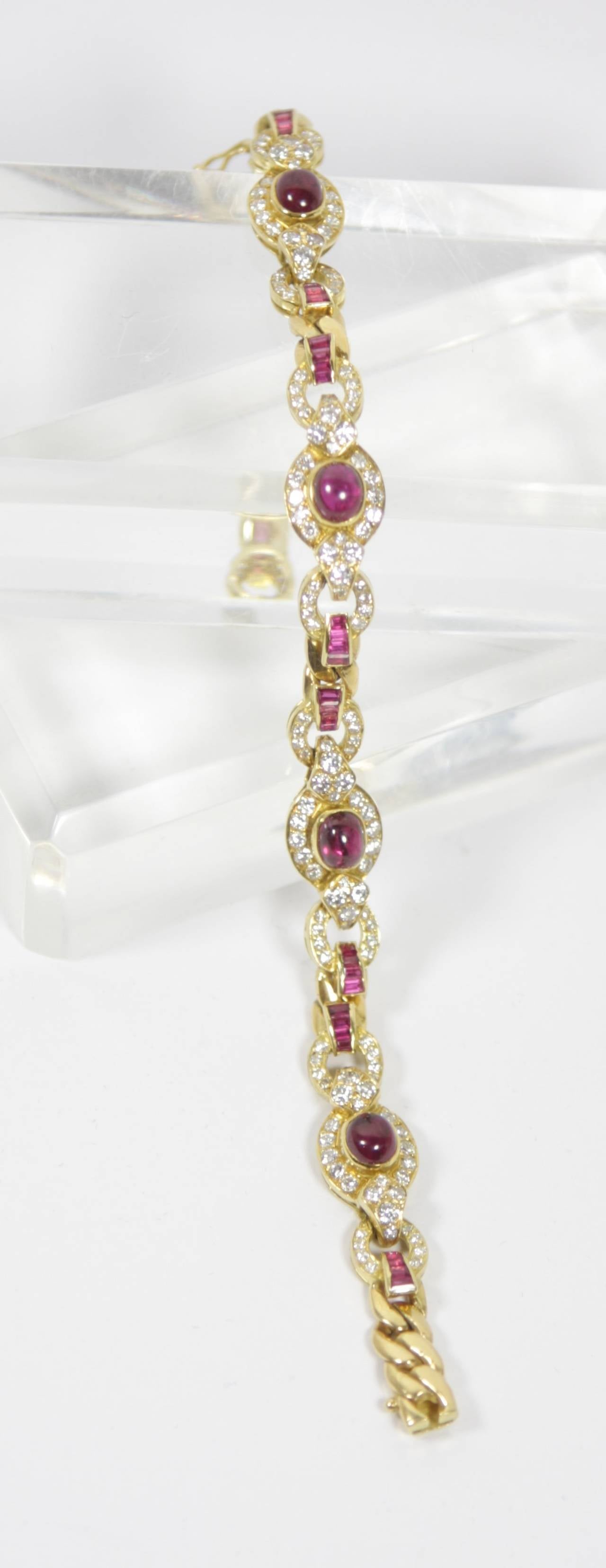 The bracelet is composed of an 18KT yellow gold which features cabachon and calibre cut rubies, along with diamonds. 

Specs:
18 KT Yellow Gold
Diamonds: 144 brilliant cut diamonds with an approximate total weight of 3.35 carats
Rubies: 4