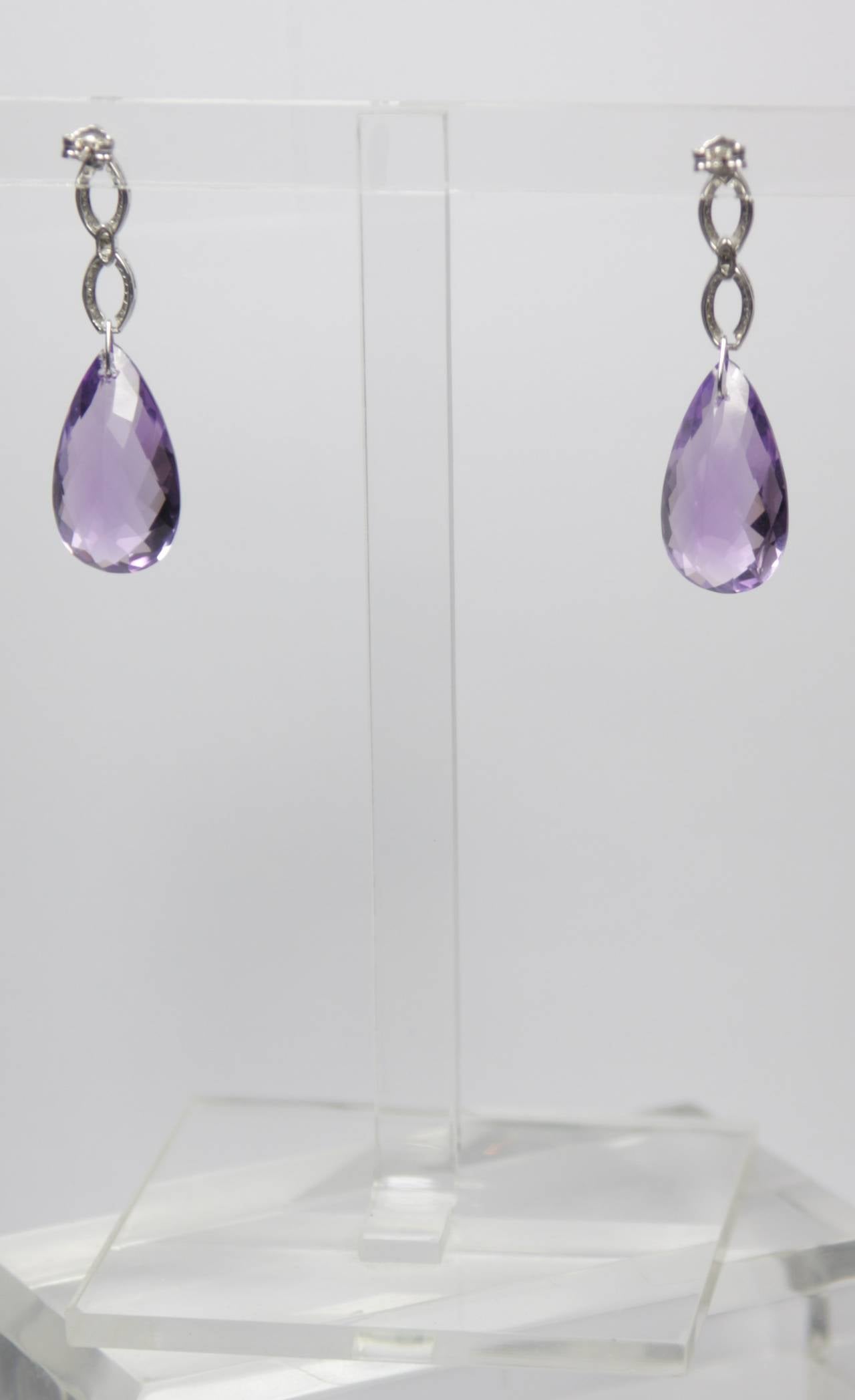 These earrings are available through The Paper Bag Princess of Beverly Hills. Please feel free to contact us with any inquiries you may have. 

These earrings are composed of white gold and Amethyst. 

Specs: 
14 KT White Gold 
Amethyst: 39.27