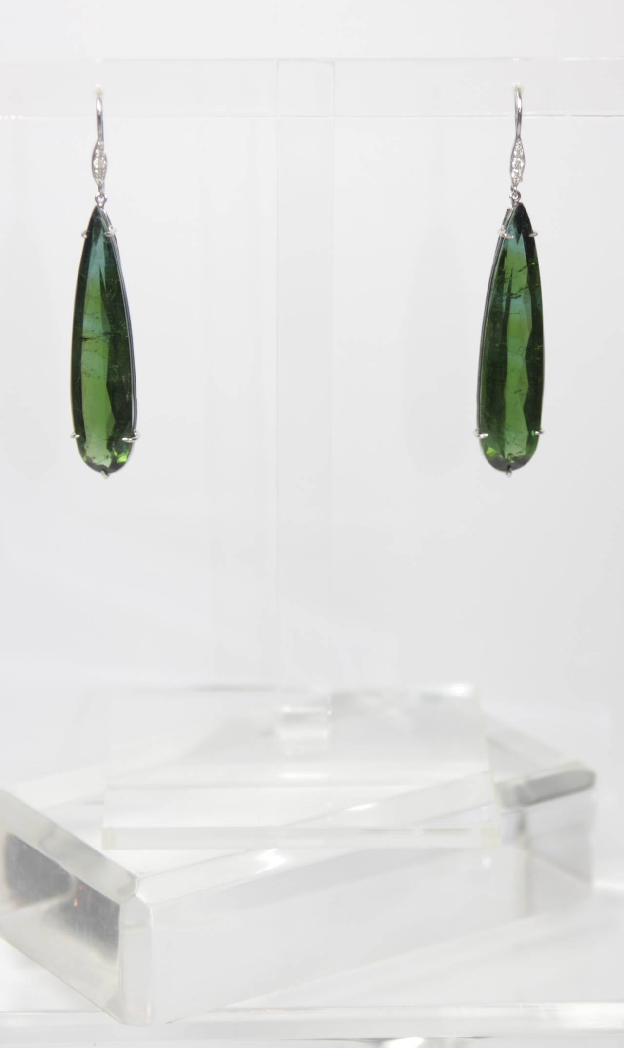 These earrings are available through The Paper Bag Princess of Beverly Hills. Please feel free to contact us with any inquiries you may have. 

These earrings are composed of a green hued tourmaline with slight variations of blue, while set in a