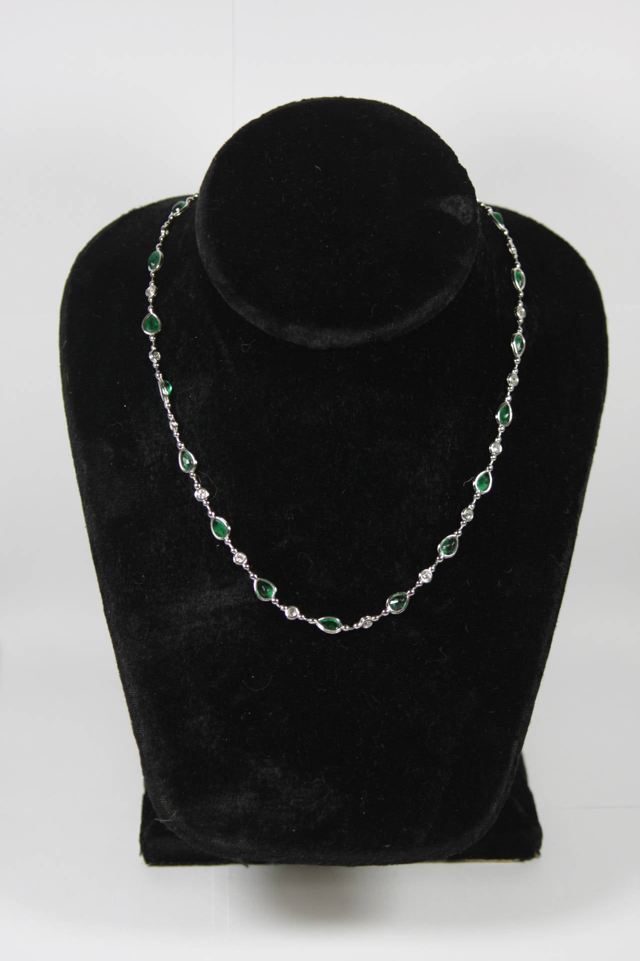 This stunning necklace is composed of platinum and features emeralds. The clasp features a stunning floating diamond.

Specs: 
Platinum  
Emeralds: 7.01 Carats Approximate Total Weight
Diamonds: 1.27 Carats Approximate Total Weight
Measures: