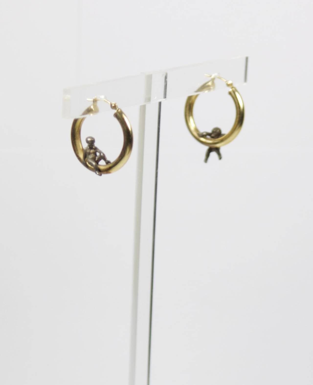 These 14kt Gold earrings are available through The Paper Bag Princess of Beverly Hills. Please feel free to contact us with any inquiries you may have. 

The earrings are composed of a 14KT yellow gold and features two angels set in the hoop