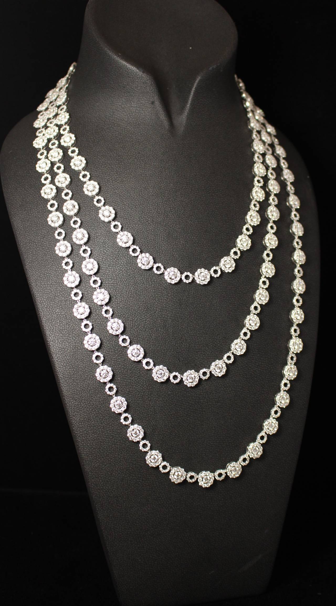 This striking necklace is composed of 18k white gold. It is set with 2060 diamonds weighting approximately 60.18 total weight.