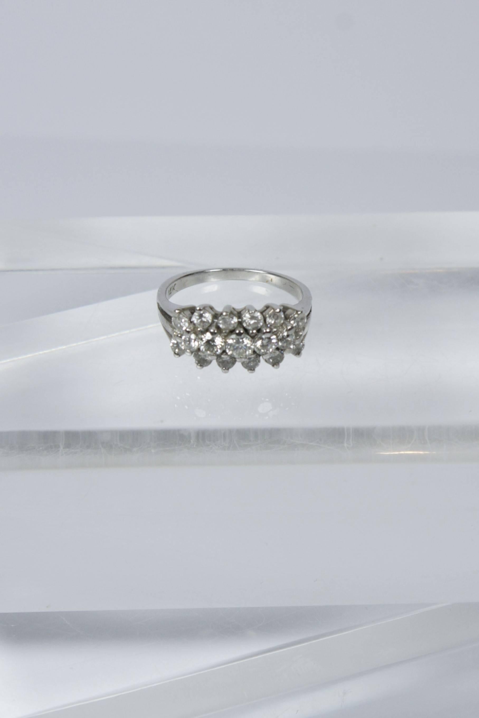 This vintage ring is available through The Paper Bag Princess of Beverly Hills. The ring is composed of 14kt white gold with three rows of diamonds. 

Specs: 
14 KT White Gold 
Size 5.5 
(Can easily be sized)