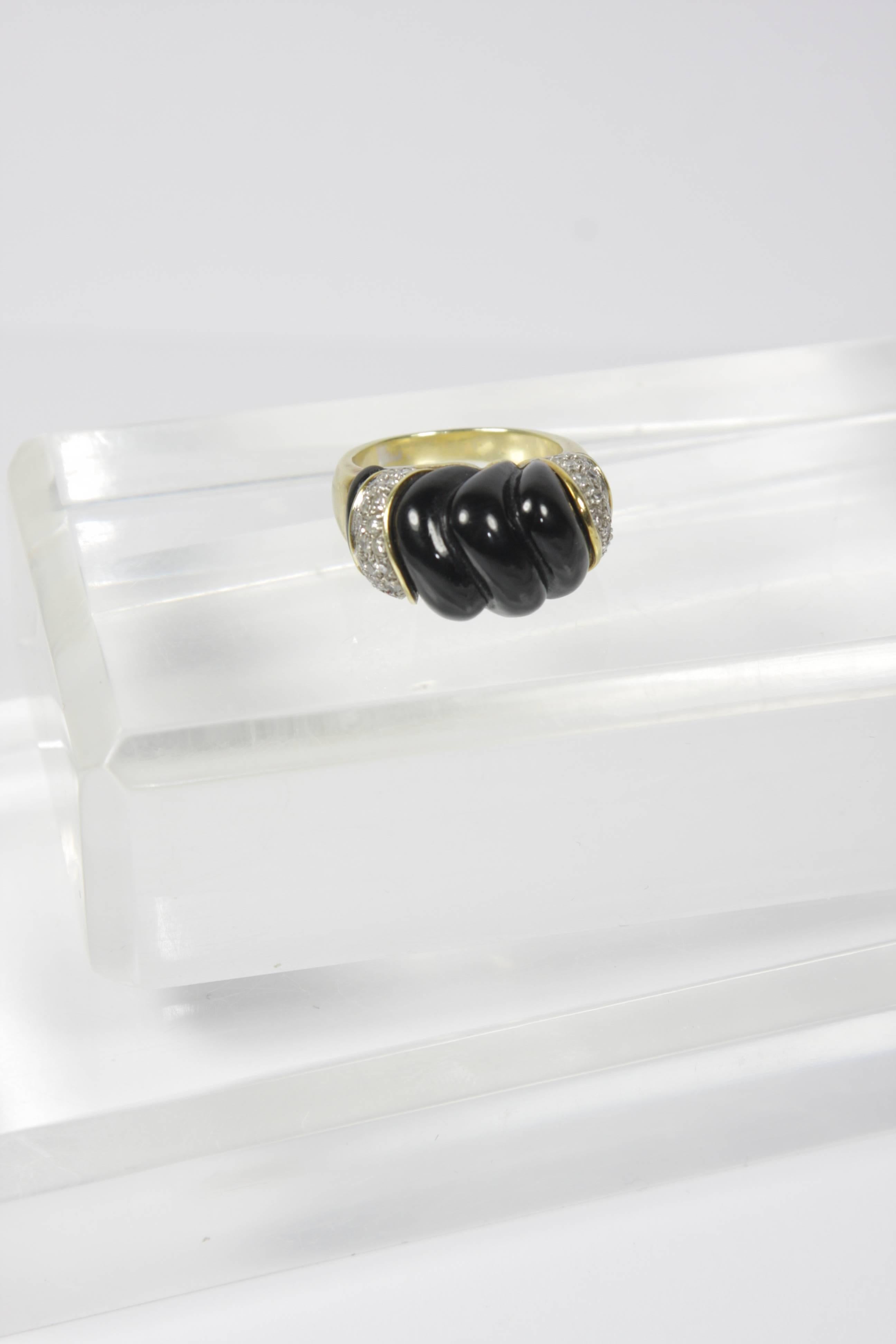 This vintage Van Cleef and Arpels inspired ring is composed of 14KT yellow gold, onyx, and is accented with pave diamonds. 

Specs: 
14 KT Yellow Gold 
Size 7