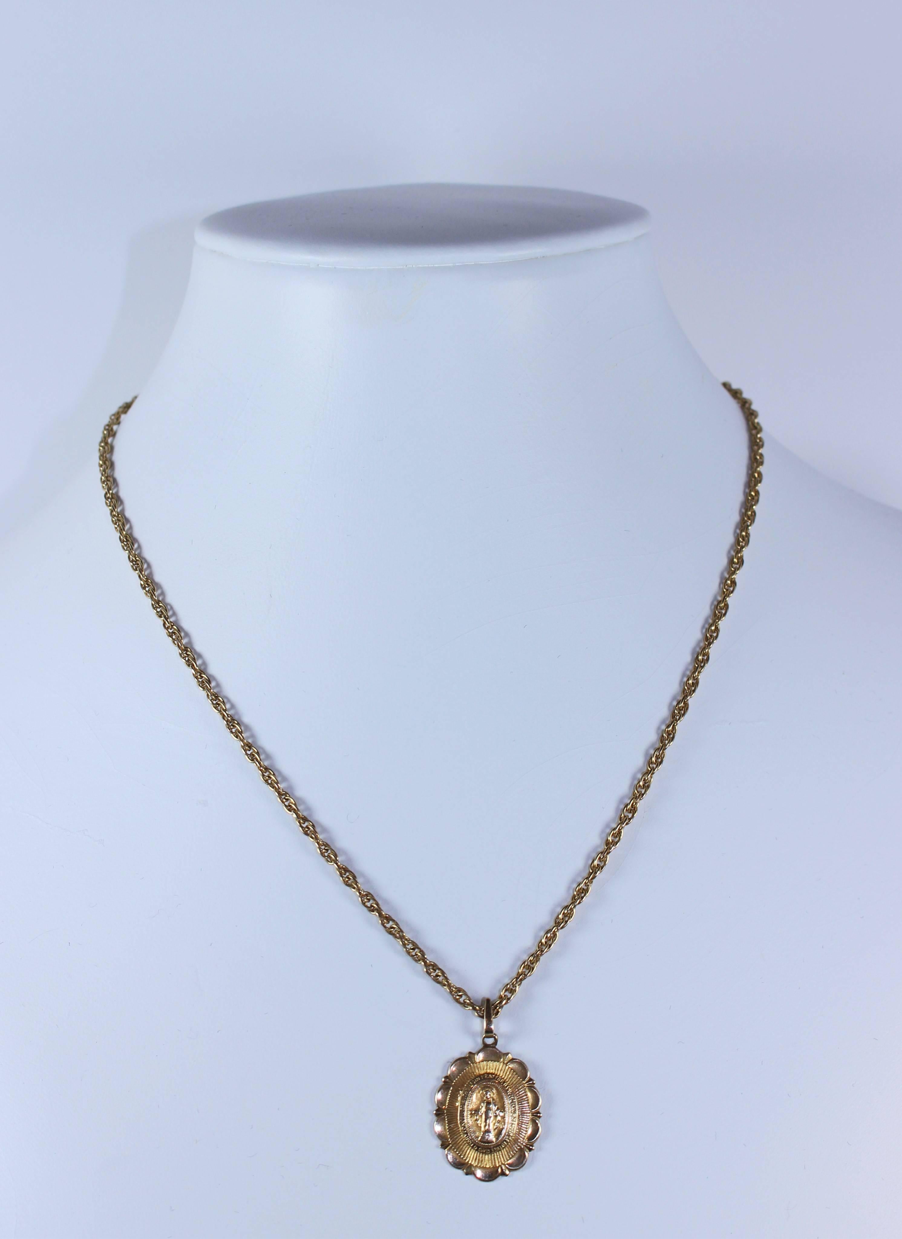 This necklace is gold filled. Features a Mary pendant and chain. Has a clasp closure. In excellent condition.

Specs: 
Yellow Gold Filled
Length: 15