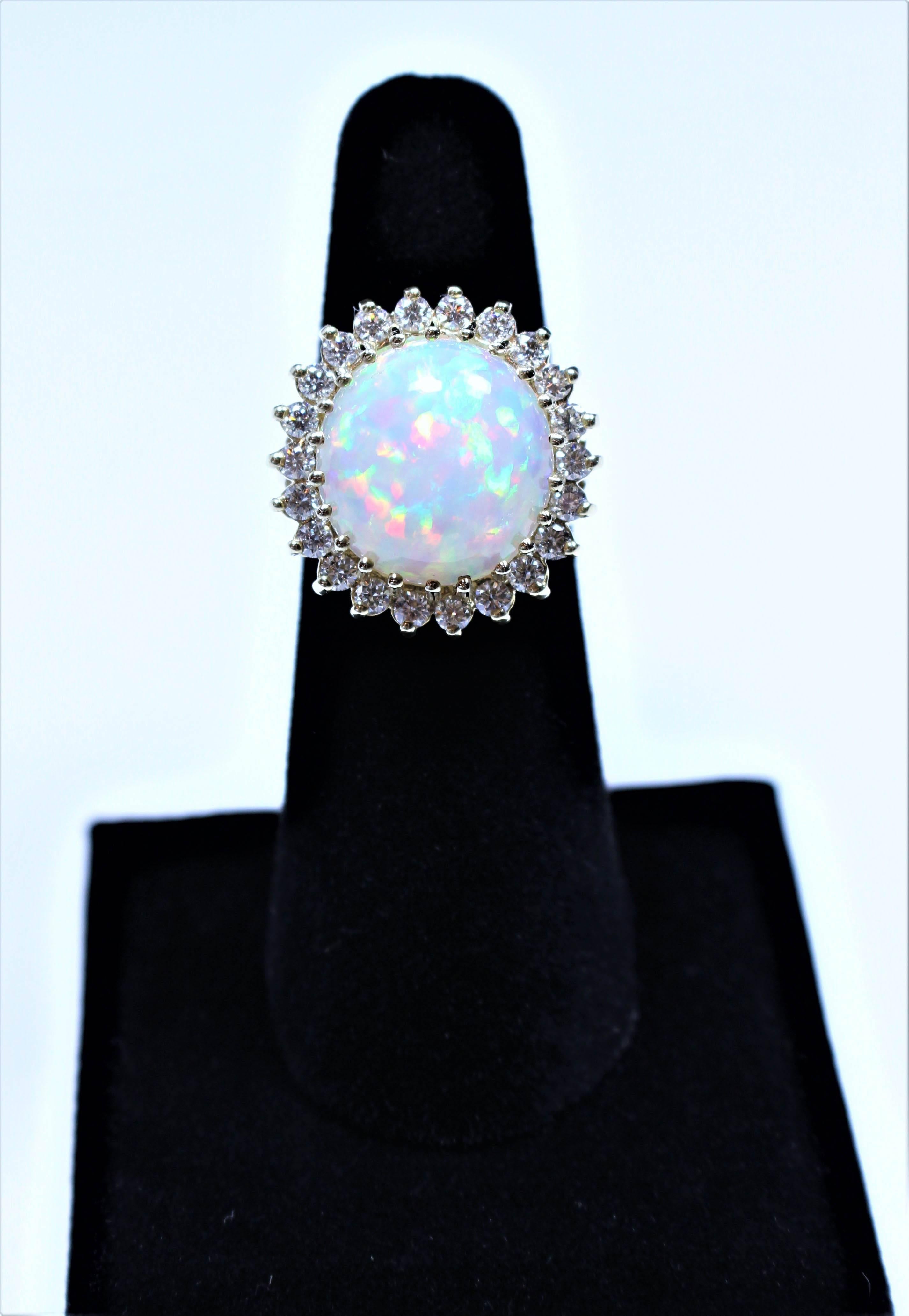 This ring is composed of 14kt yellow gold and features a vibrant Opal center stone, which is approximately 8.11 carats. There are 22 round cut diamonds accenting the center stone. In excellent condition. Size 6.5 easily sizable.

Please feel free