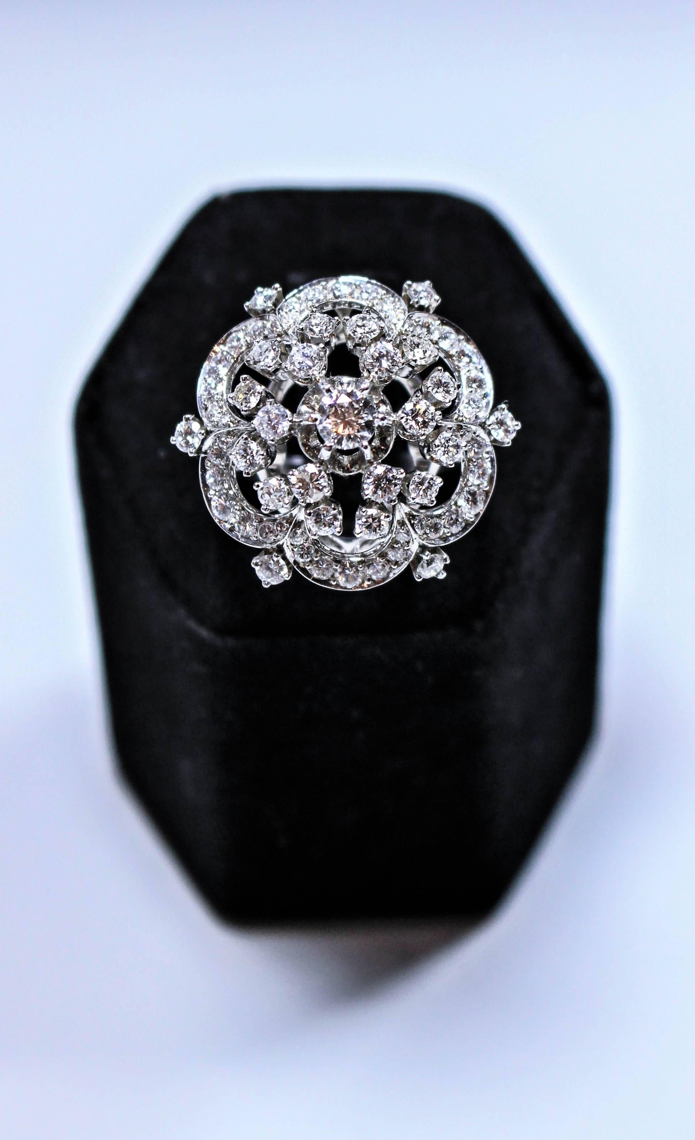 This brooch style ring is composed of platinum and diamonds, Features a 0.25 carat center stone with 66 smaller diamonds accented throughout. A beautiful and stunning timeless design, so chic. Size 6.5 easily sizable.

Please feel free to ask any