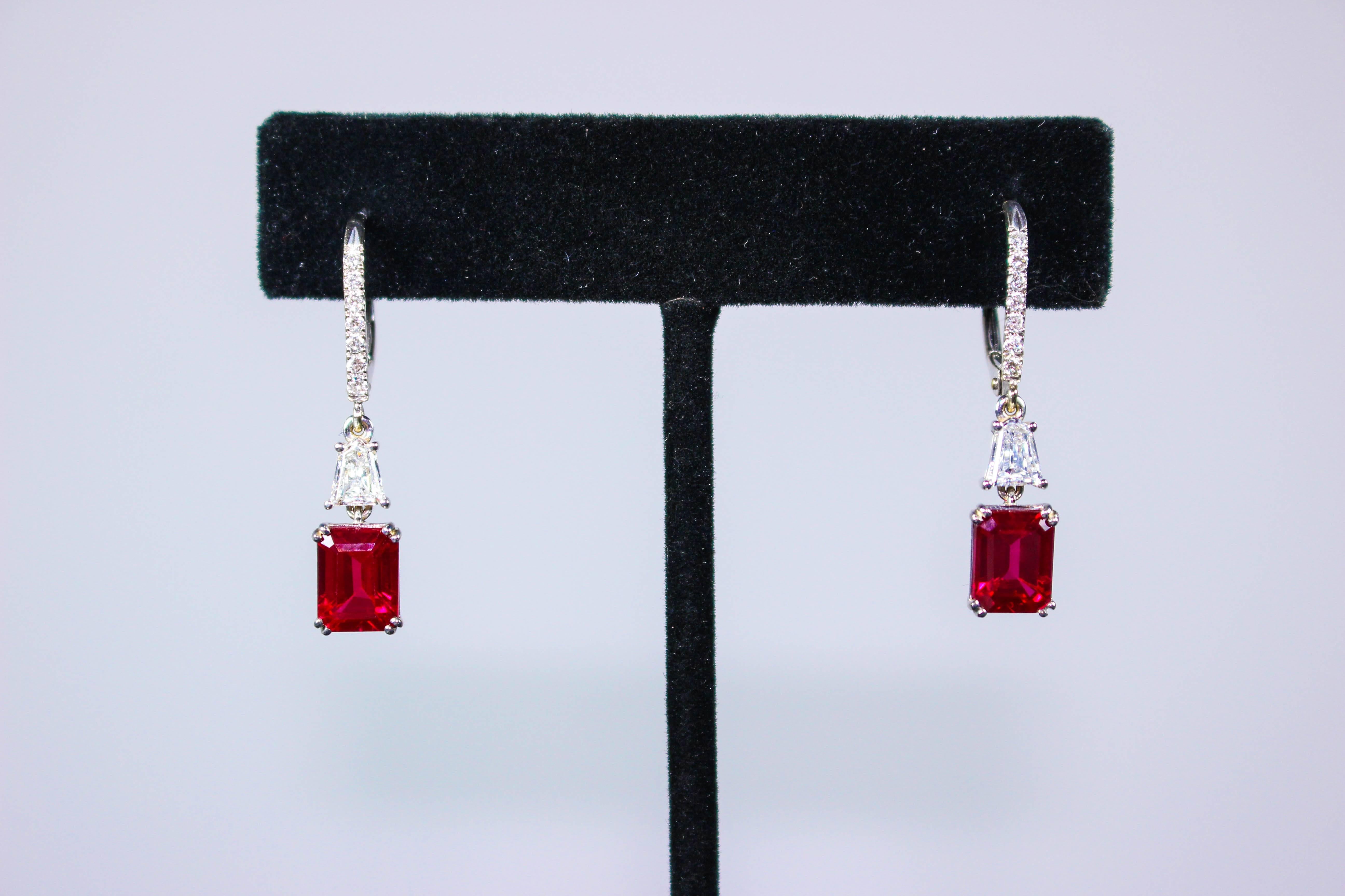 These earrings are composed of 14KT white gold and emerald cut Ruby center stones, with Trillion cut diamond accents, and pave detailing. Stunning earrings in excellent condition.

Please feel free to ask any questions you may have, we are happy to