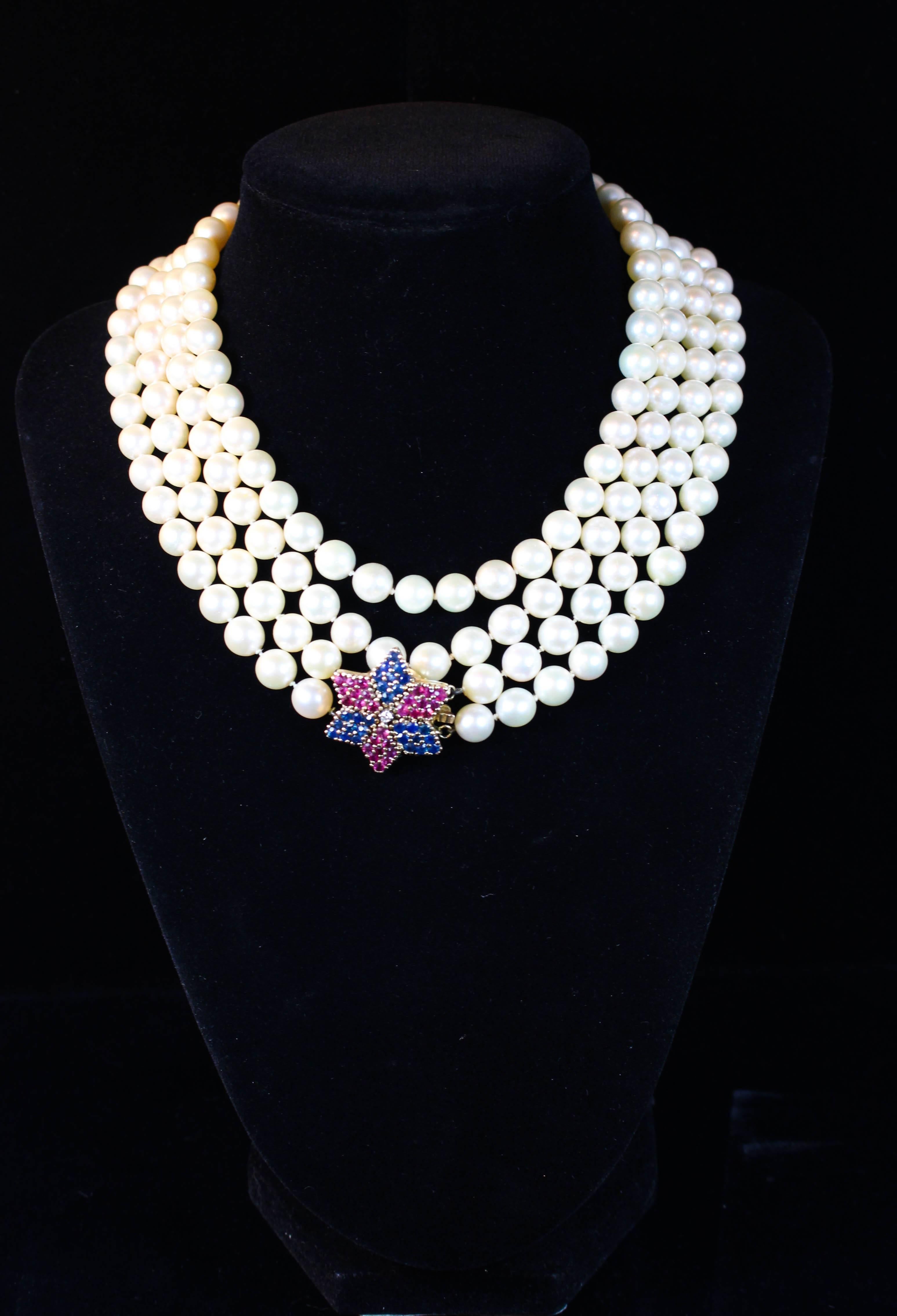 This necklace is composed of a double strand of pearls with a stunning 14kt gold clasp with rubies and sapphires. Can be styled in a variety of ways. Specs below. In excellent condition.

Please feel free to ask any questions you may have, we are