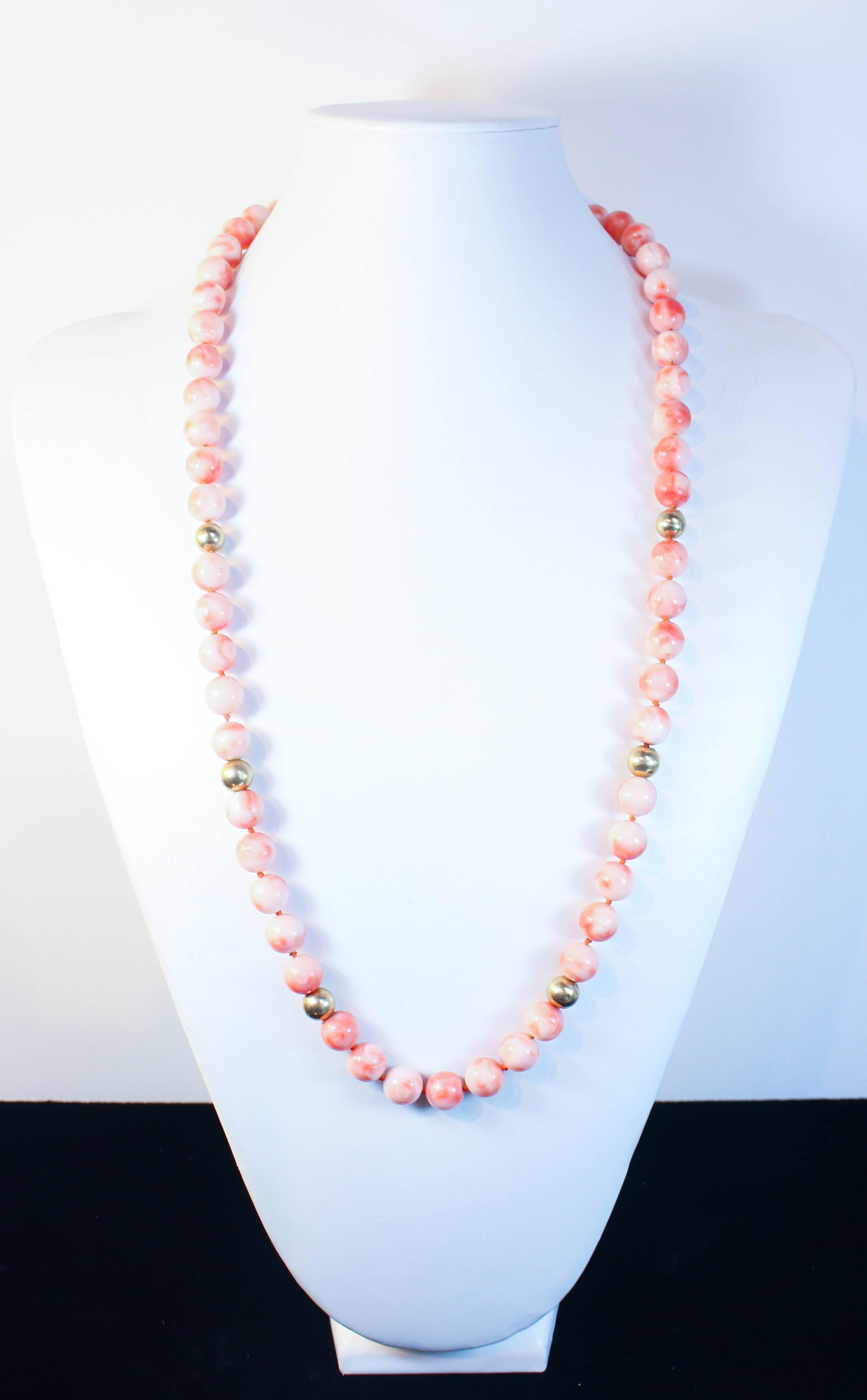 This necklace is composed of light coral beads with an approximate 11mm size. Features gold bead accents. In excellent condition.

Please feel free to ask any questions you may have, we are happy to assist. 

Specs:
14KT Yellow Gold Beads
Coral