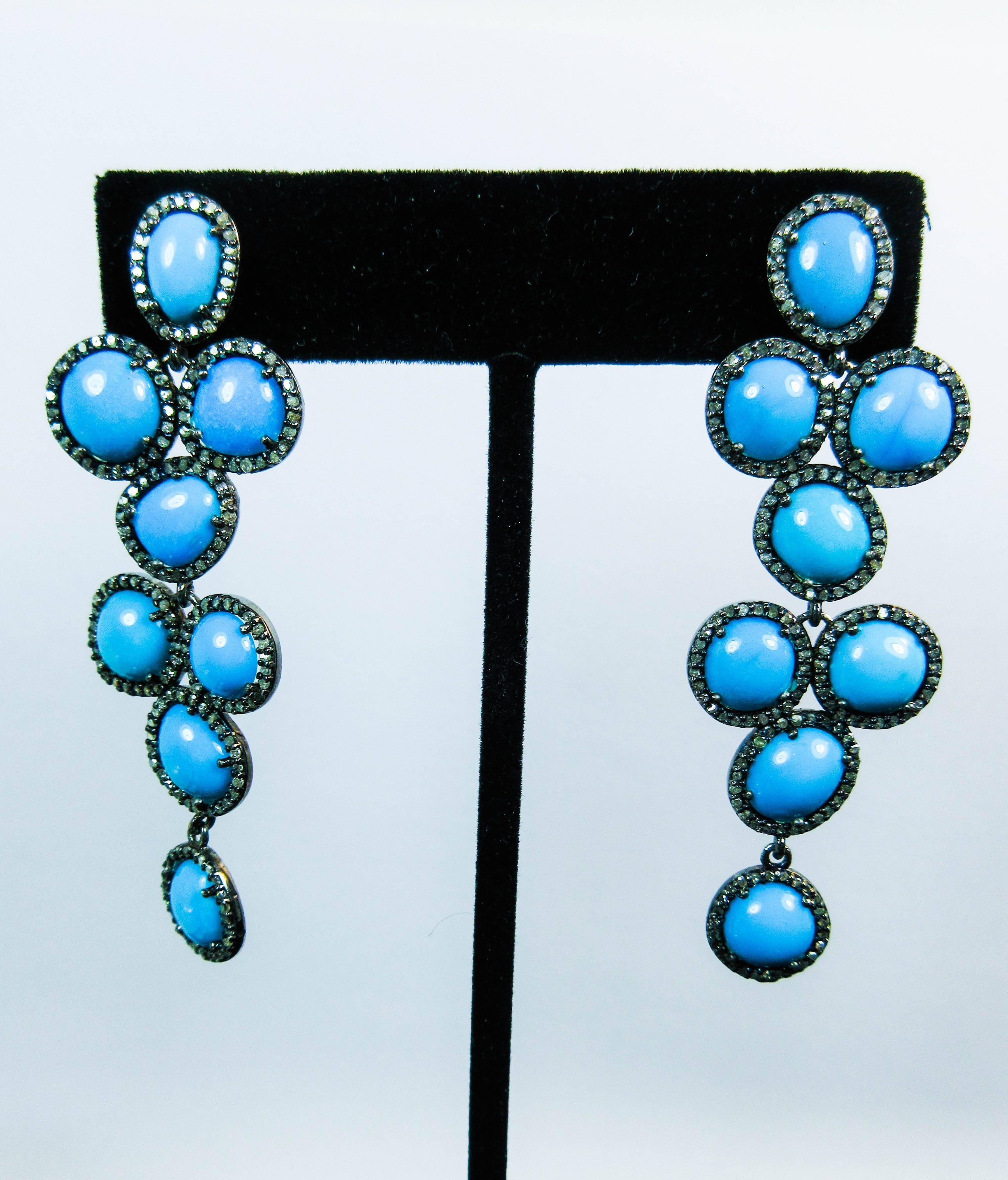These earrings are composed of turquoise set in silver with pave diamond accents. Features 14KT gold post. In excellent condition.

Please feel free to ask any questions you may have, we are happy to assist. 

Specs:
Silver
Approximately 1.58 Carats