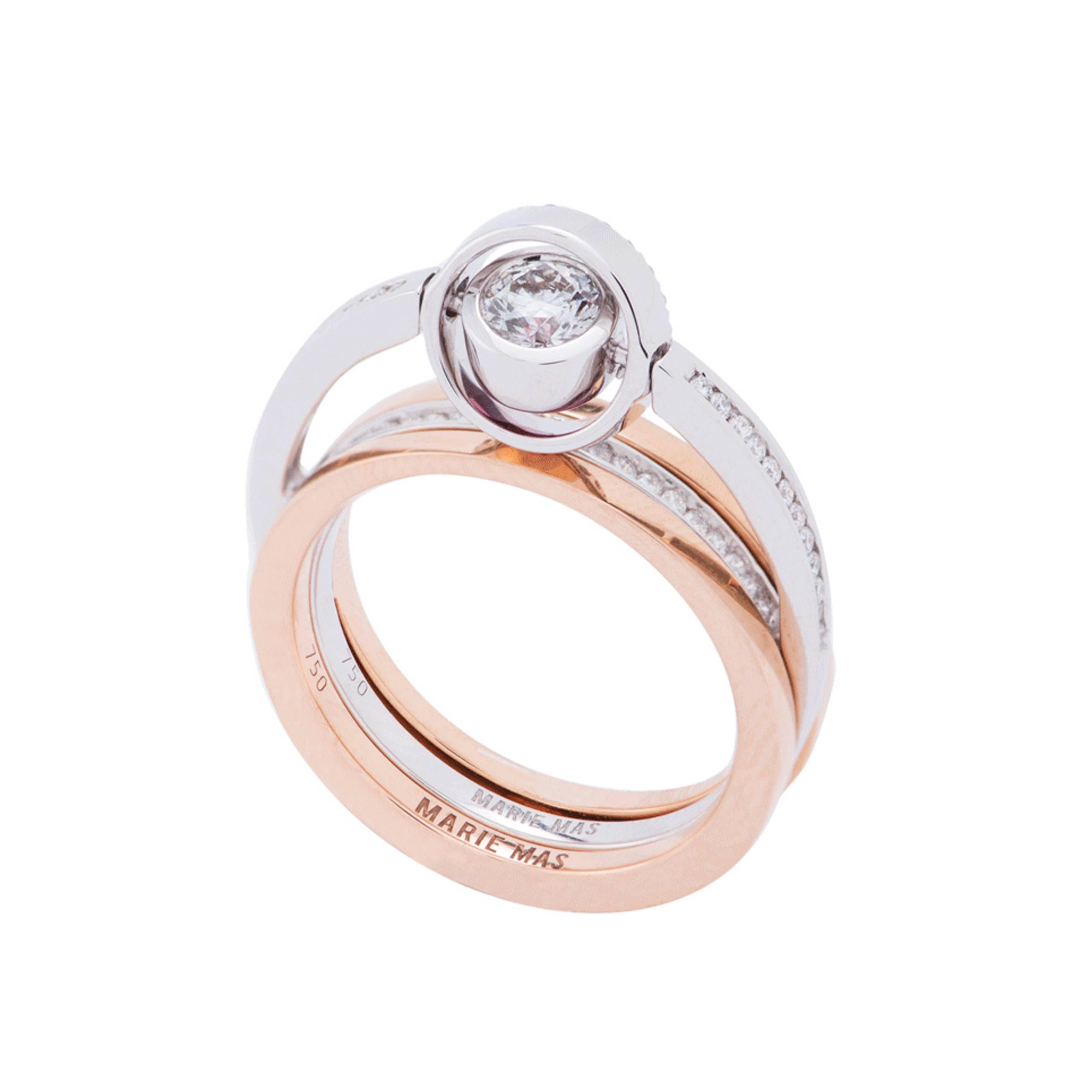 This Jewel from Marie Mas is made by two rings : the Swiveling Engagement Ring and the Swiveling Wedding Band. They can be worn together or separately. The Swiveling Engagement Ring is in 18 Karat White Gold, with Diamonds and a Pink Tourmaline. The