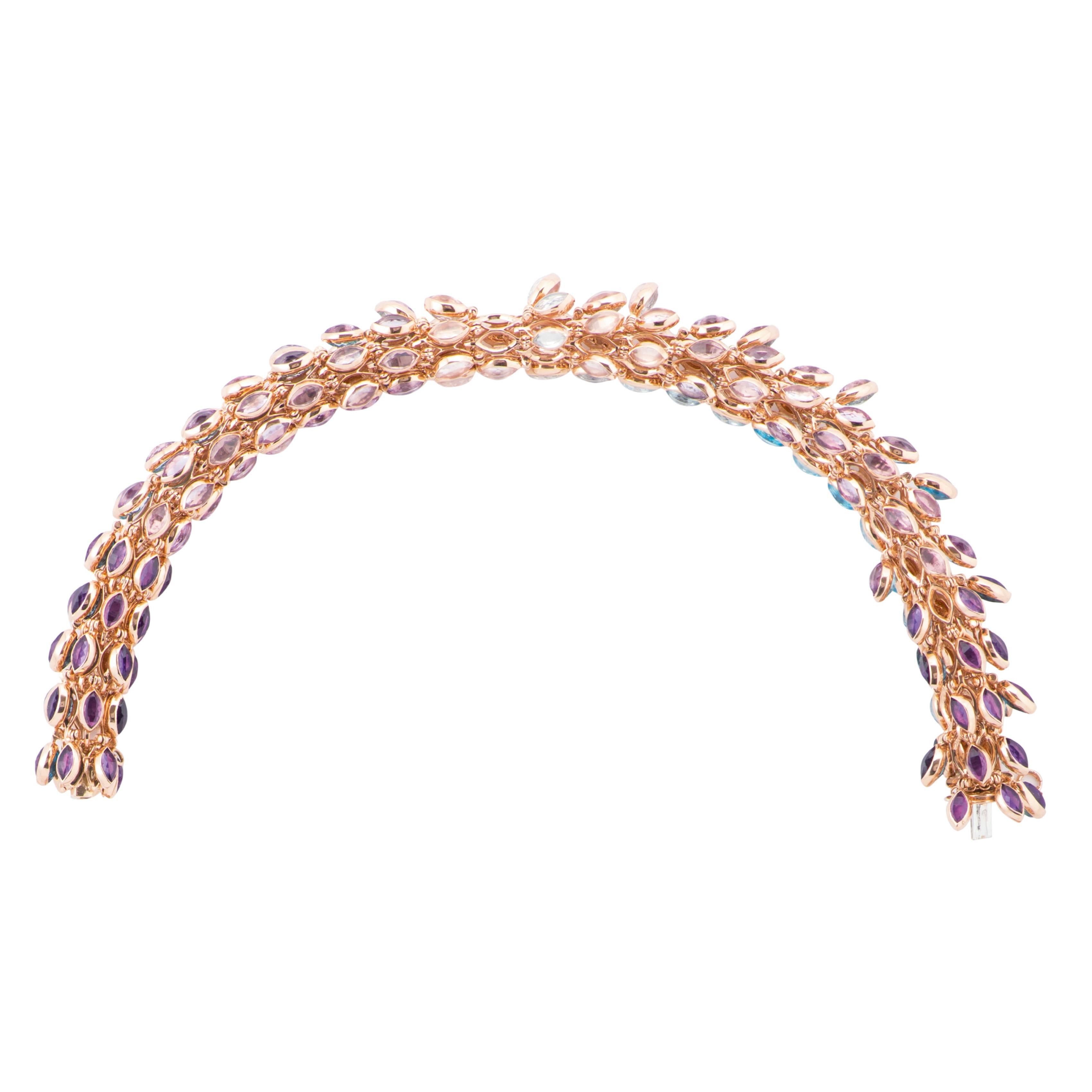 This Bracelet is a High Jewelry piece from Marie Mas' Swinging Stones collection. 
On the outside part of the bracelet, all the stones are articulated. They are set back to back (with a different color of stone on each side) and the bracelet moves