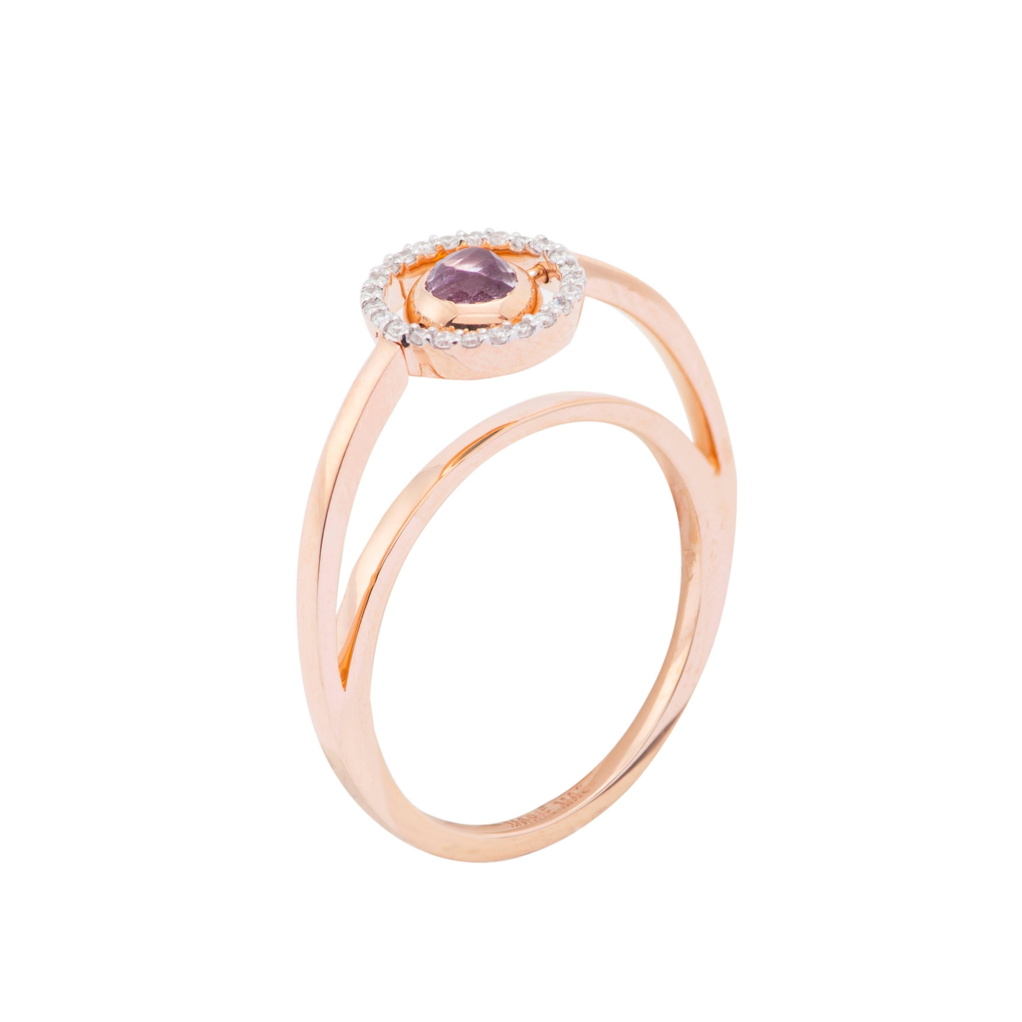 This Swiveling Ring is designed by the French Jewelry brand Marie Mas. 
The ring is 18 Karat Rose Gold, with Diamonds, Pink Amethyst and London Blue Topaz. The center stone is reversible : there is a Pink Amethyst and a London Blue Topaz back to