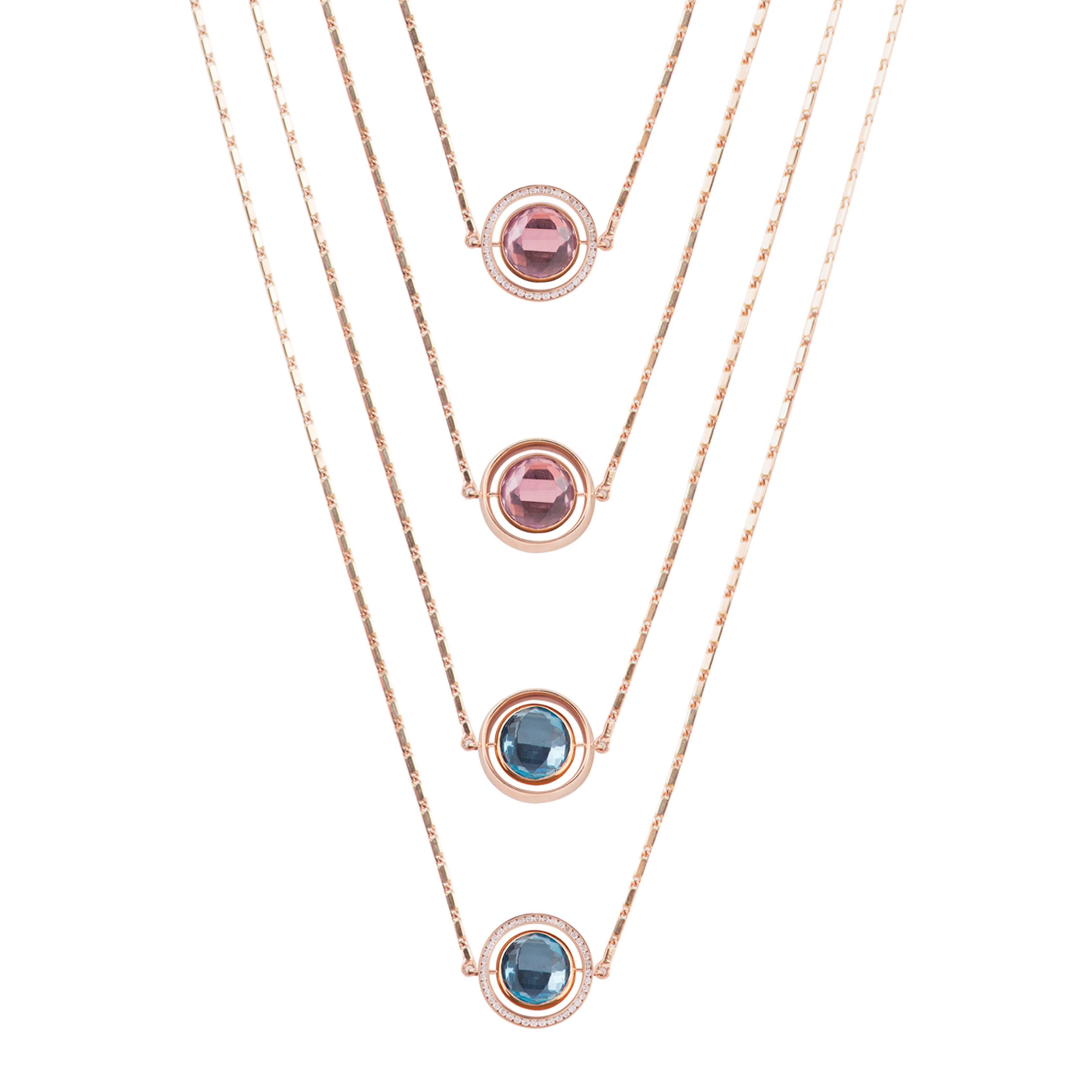 This Small Swiveling Necklace is designed by the French Jewelry brand Marie Mas. 
The necklace is in 18 Carat Pink Gold, with Diamonds, Pink Amethyst and London Blue Topaz. The center stone is reversible : there is an Pink Amethyst and a London Blue