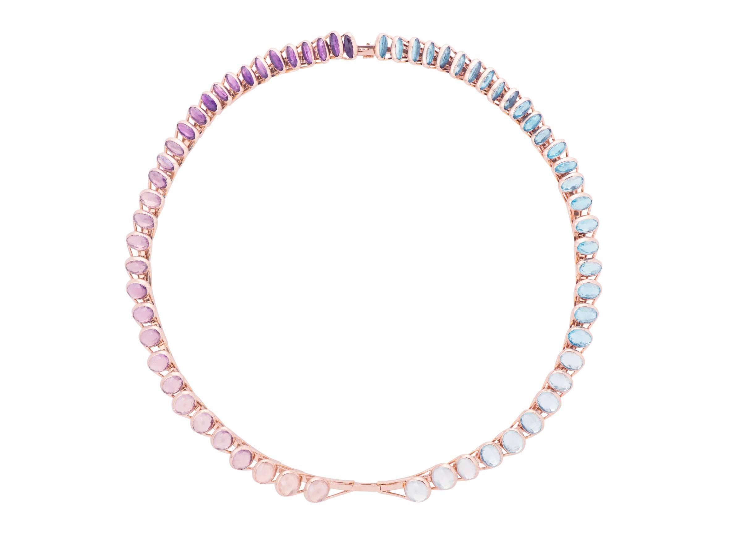 This transformable Necklace, in 18 Carat Pink Gold is set with shades of Amethysts, quartz, and Topaz. All the stones are set by two, back to back. On one side there is a shade of purple and on the other side there is a shade of blue. All the stones